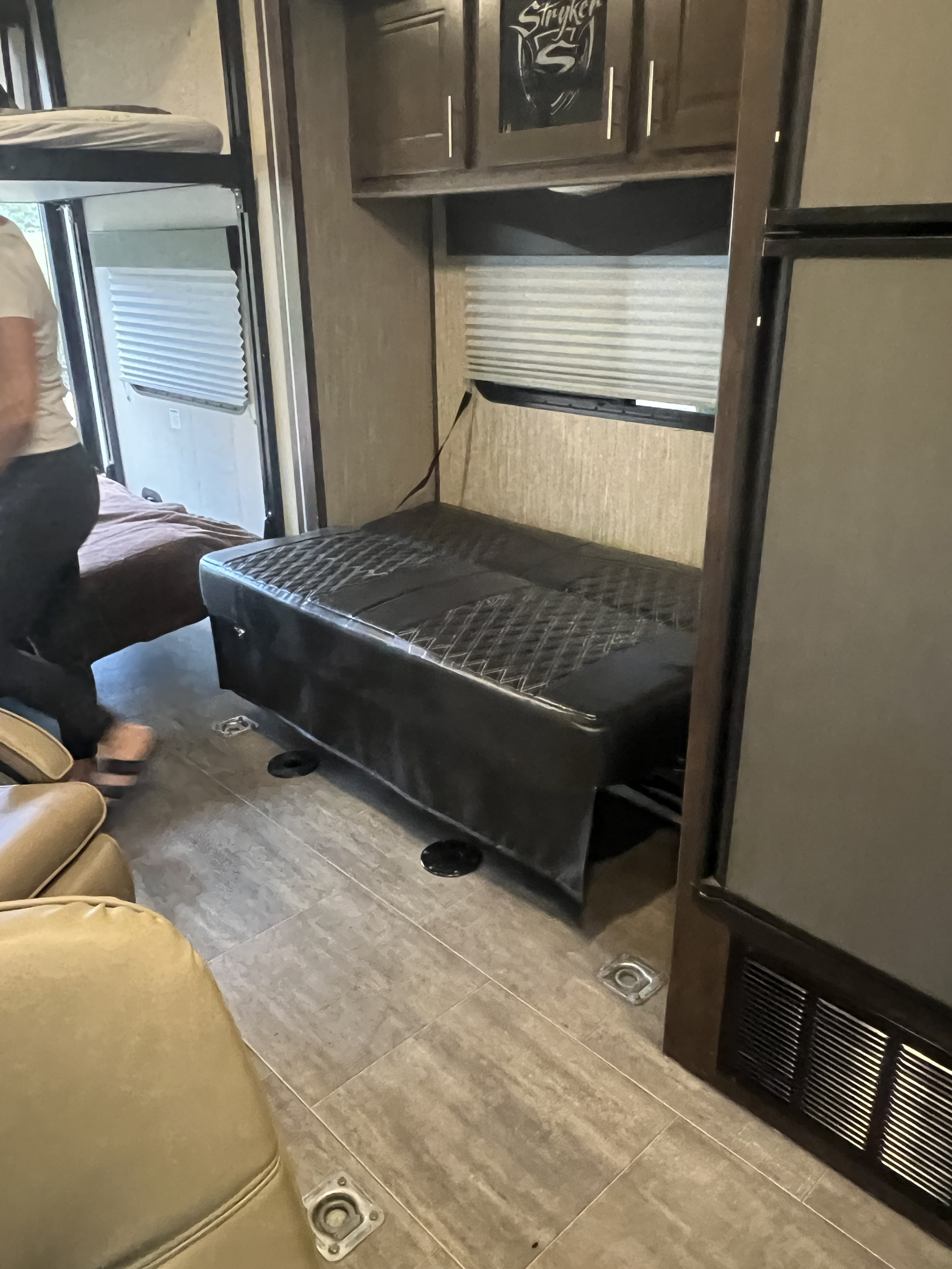RV rental interior features a convertible sofa bed, an upper bunk, and durable flooring with tie-downs, perfect for gear.. Cruiser Rv Corp Stryker 2018