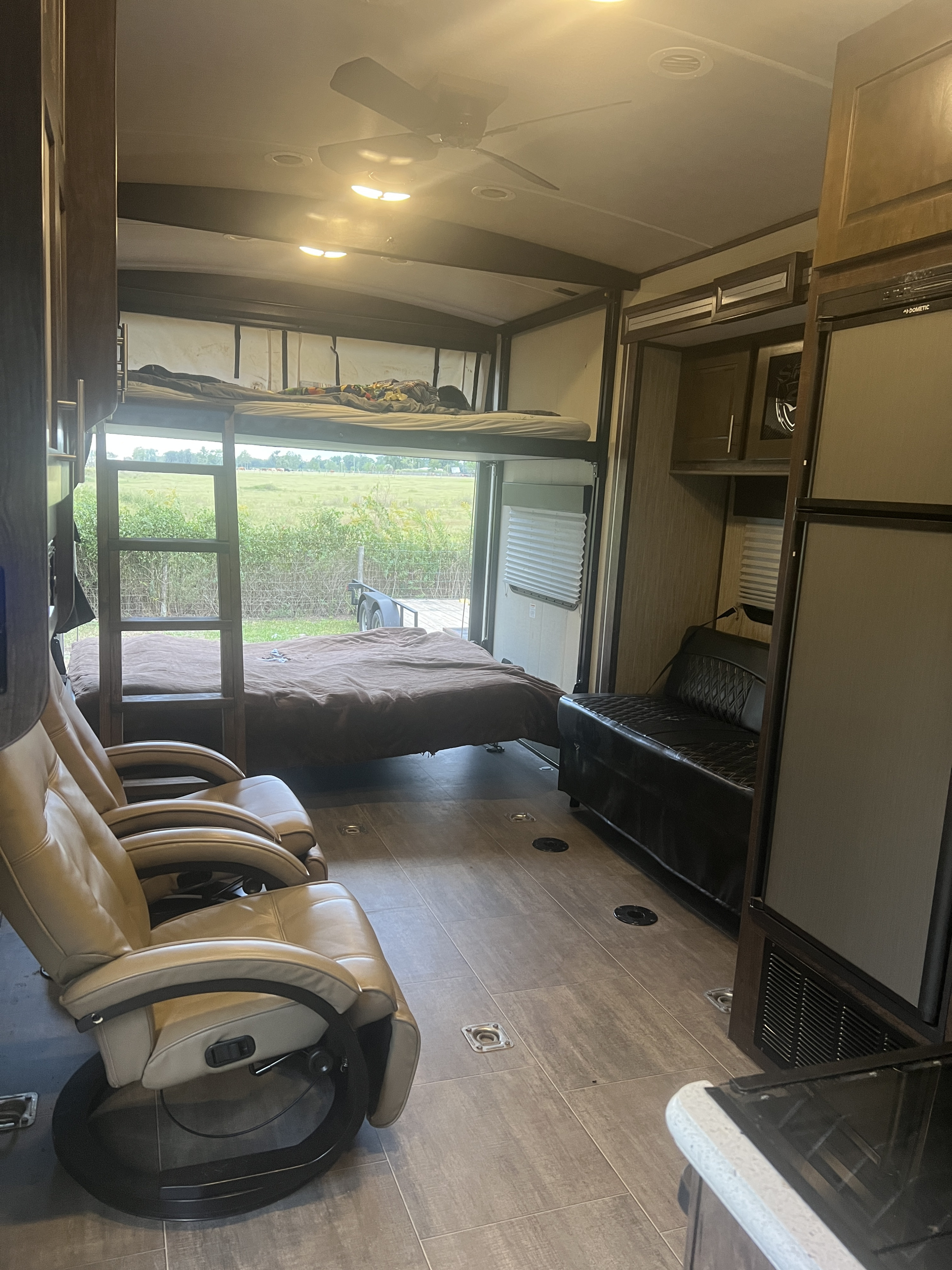 Spacious RV rental interior featuring bunk beds, comfy recliners, a sofa, and a scenic view. Perfect for family adventures.. Cruiser Rv Corp Stryker 2018