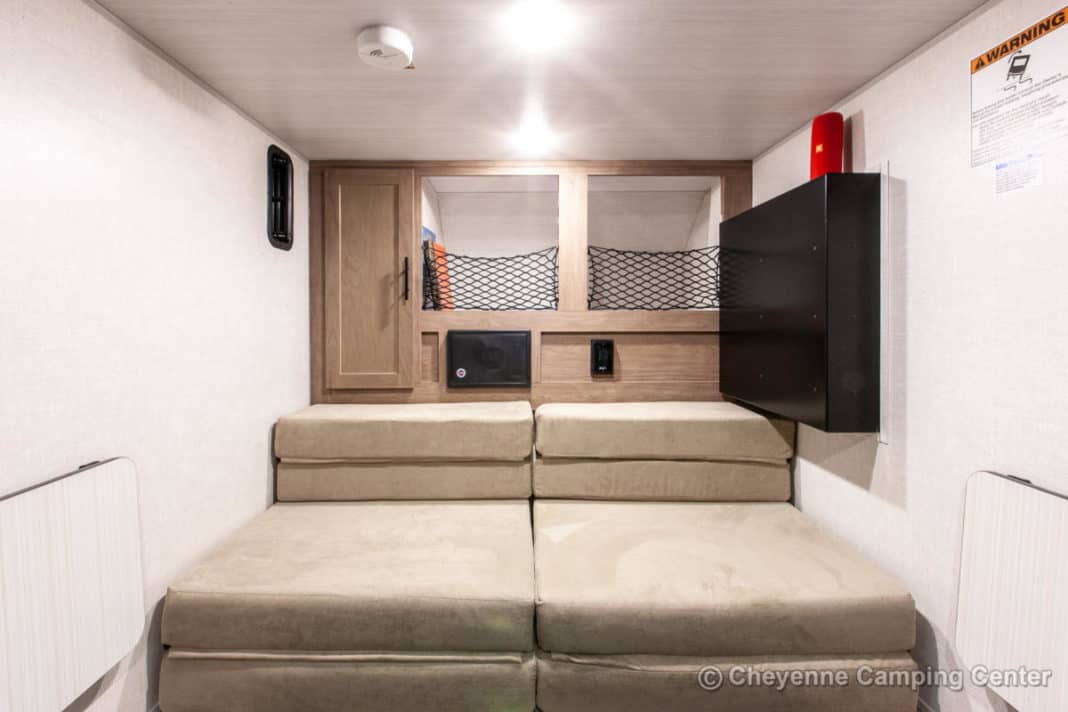 This rv rental features twin beds, overhead storage nets, and a space-saving fold-down table in a compact interior.. Forest River No Boundaries 2021