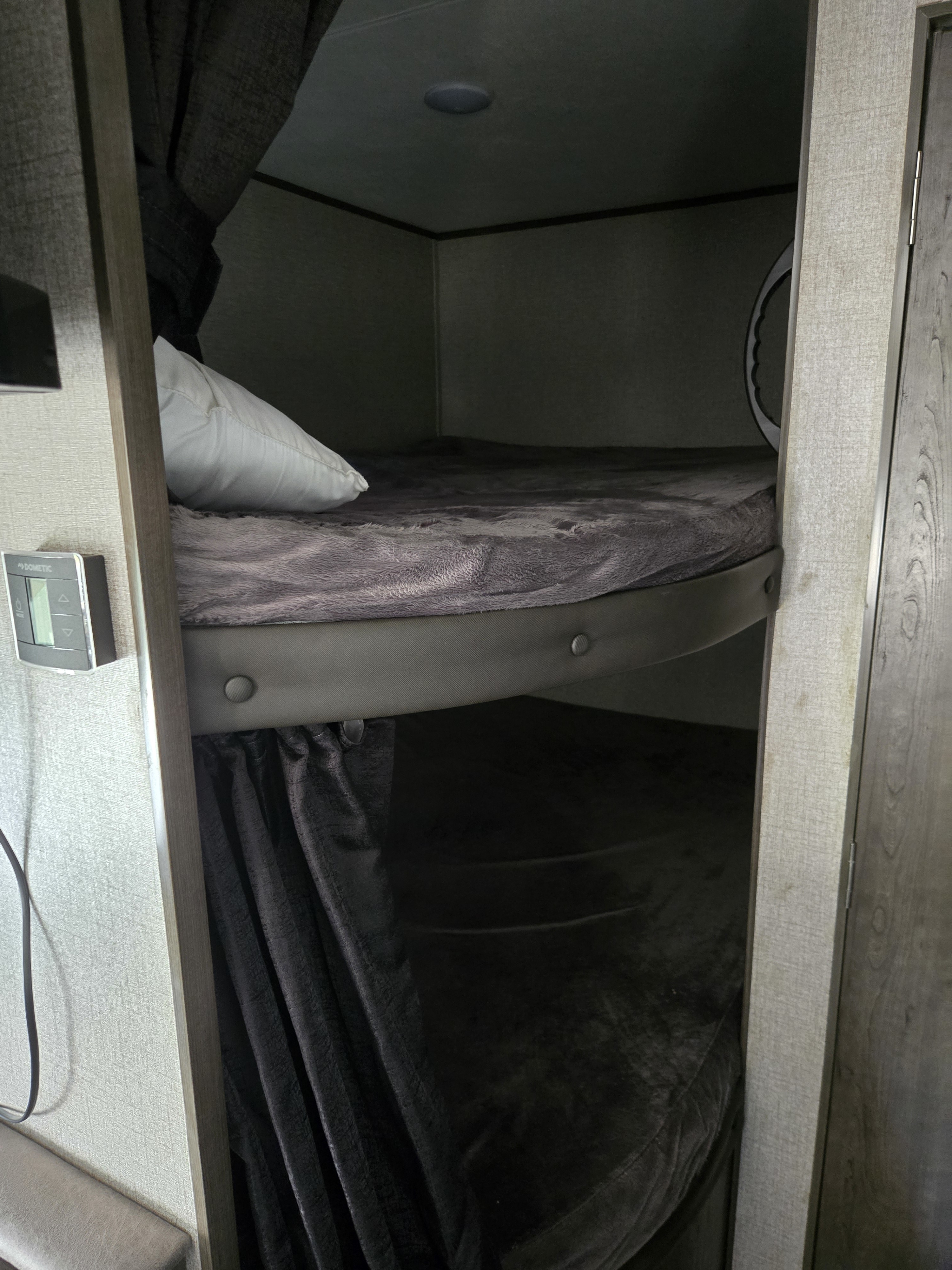 Cozy RV rental bunk beds with soft blankets & Dometic control panel for a comfortable stay.. Jayco Jay Flight SLX 2021