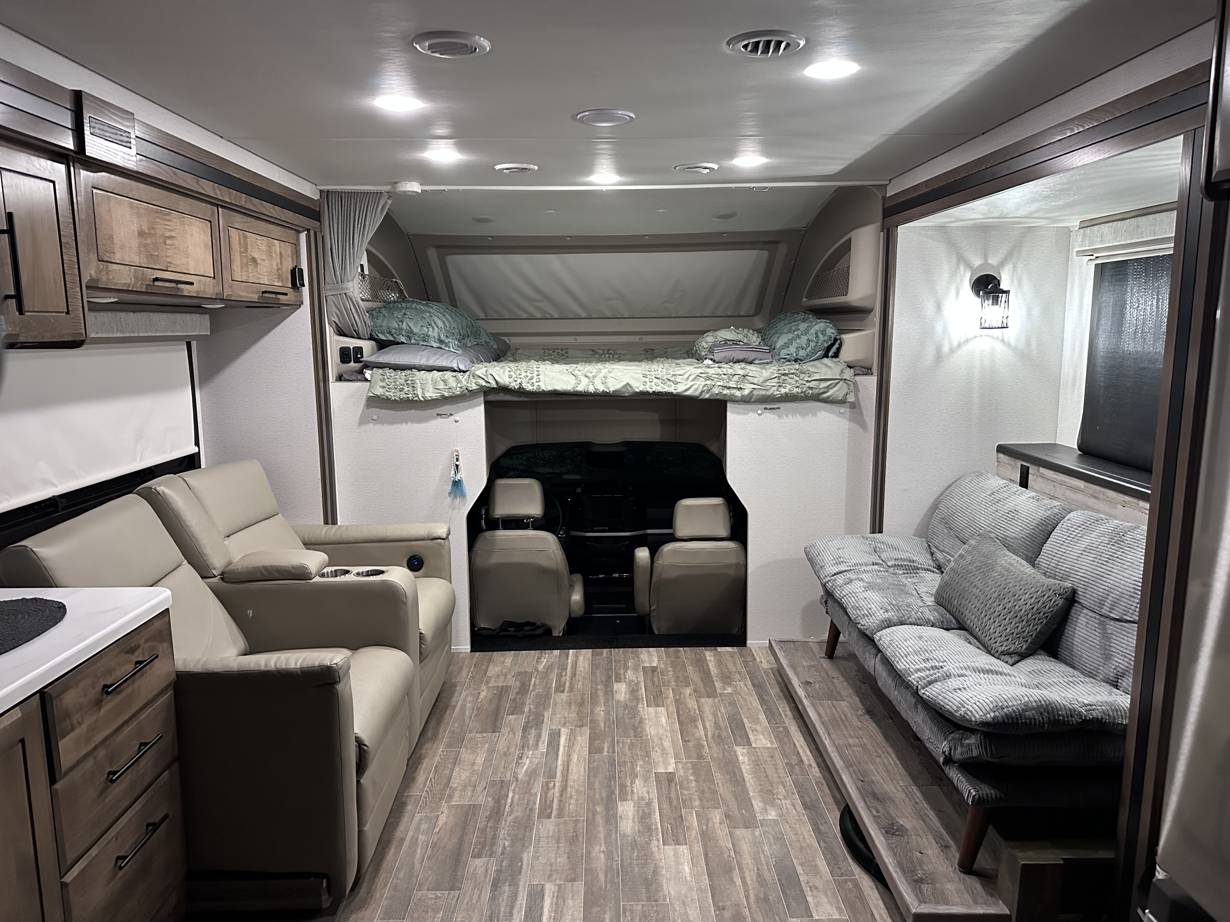 RV rental interior featuring a cozy living space, cab-over bunk bed, and driver's cabin.. Entegra Coach Accolade XT 2024