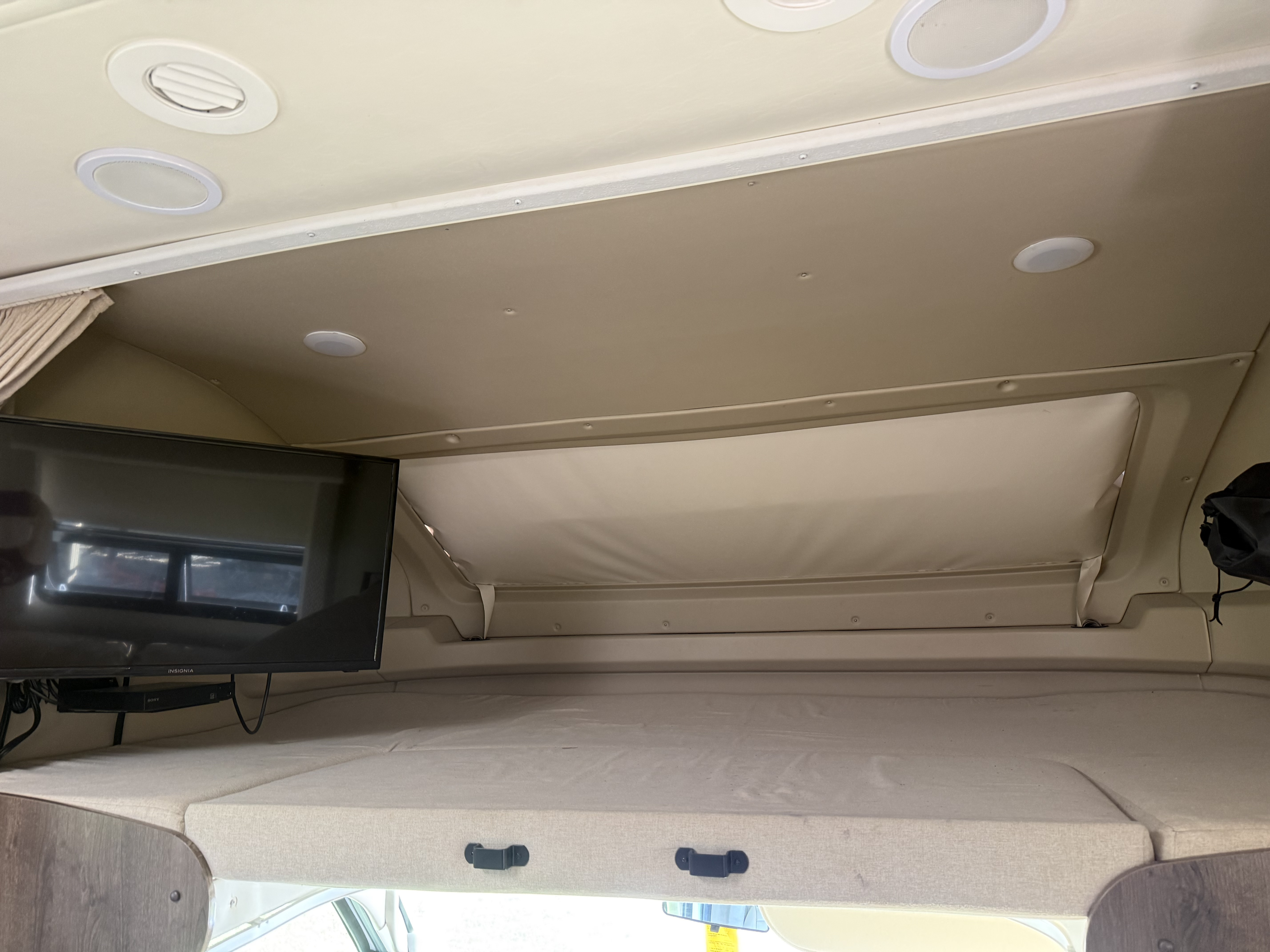 RV rental interior: Overhead bunk bed with TV, ceiling lights, vents, and front handles. Perfect for extra sleeping space.. Entegra Coach Esteem 2020