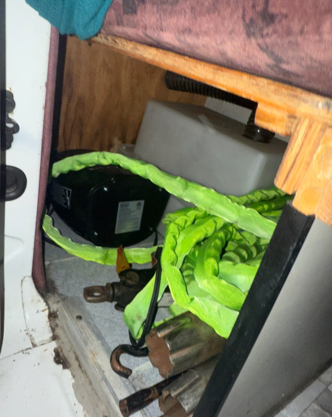 RV rental under-bed storage: water tank, heater, green strap, & tools. Essential utilities for van life camping.. Dodge B Van 1998