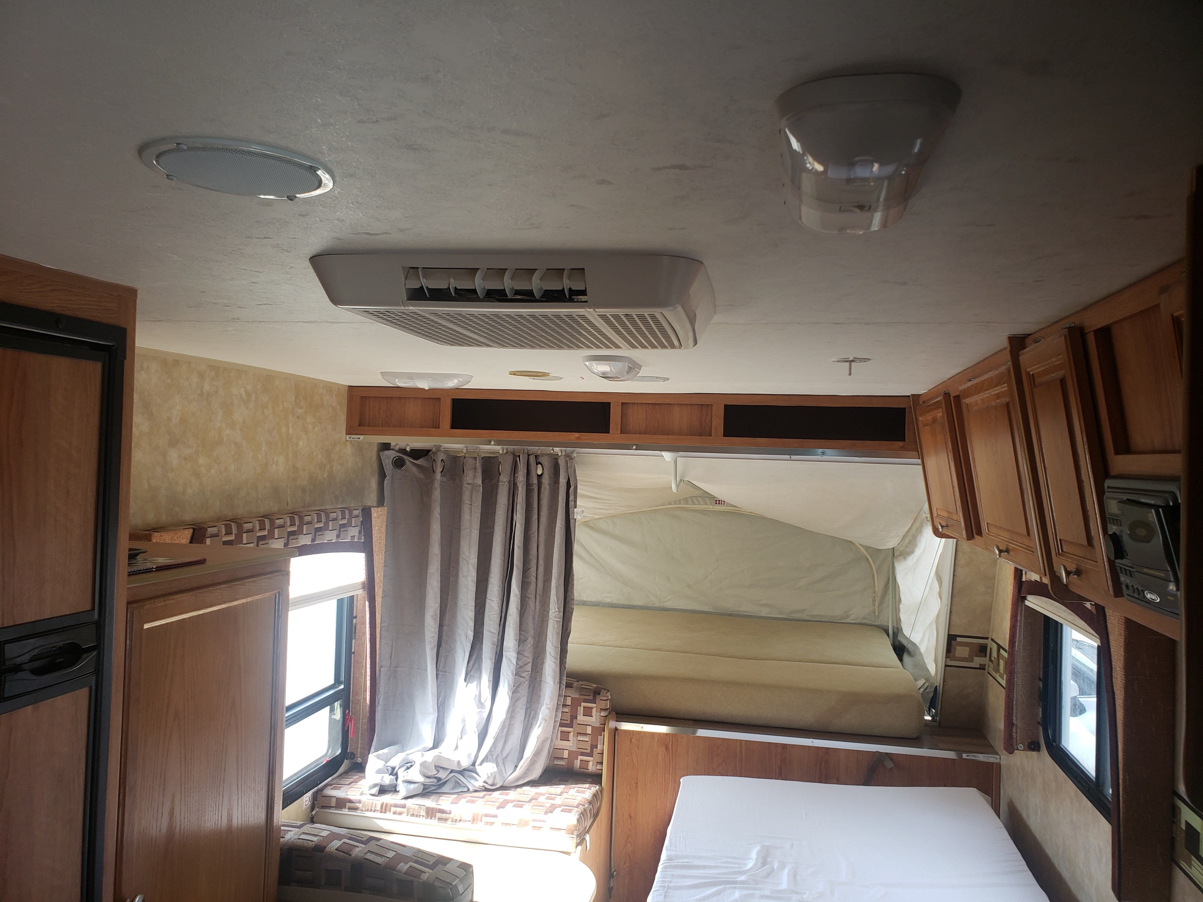 Cozy RV rental interior featuring a central AC, cabinets, fridge, and comfortable sleeping areas. Ready for adventure!. Jayco Jay Feather EXP 2008