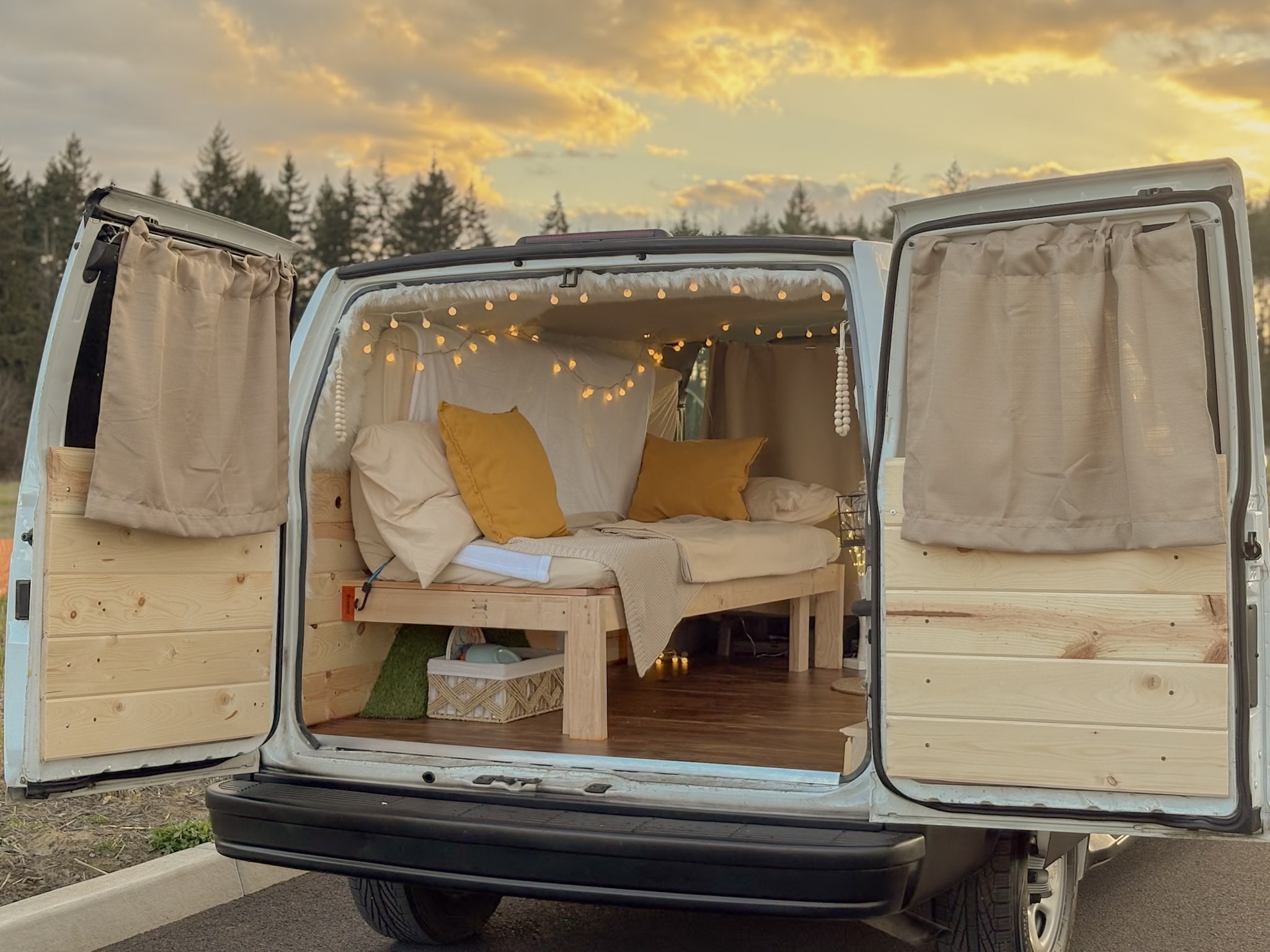 Explore in comfort with this charming van conversion! An ideal rv rental featuring a cozy bed, string lights, and wooden interior.. Chevrolet Astro 2005
