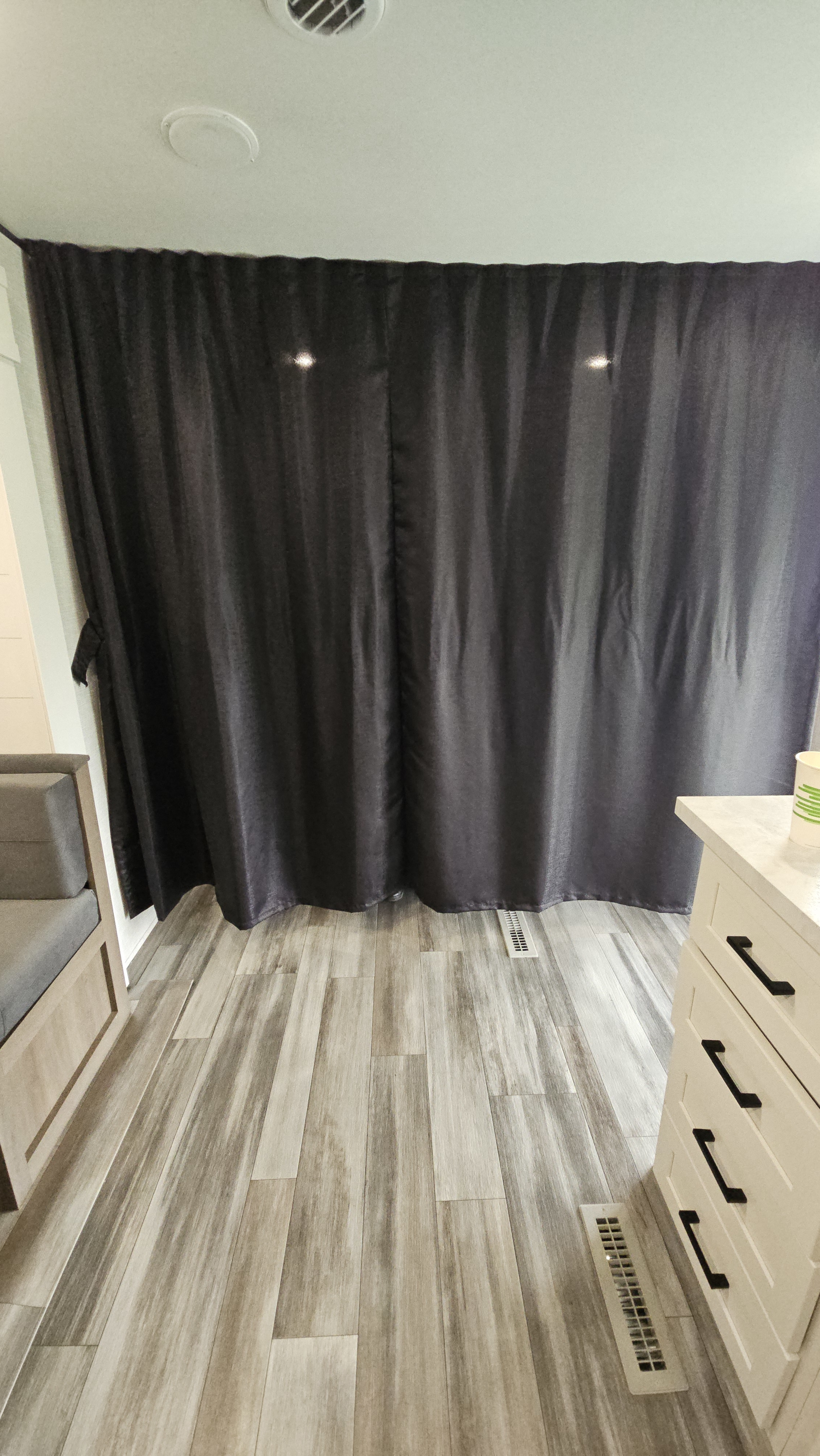 RV rental interior: Dark privacy curtains, wood-look flooring, and functional cabinetry. A comfortable and well-equipped space.. Jayco Jay Flight SLX 2025