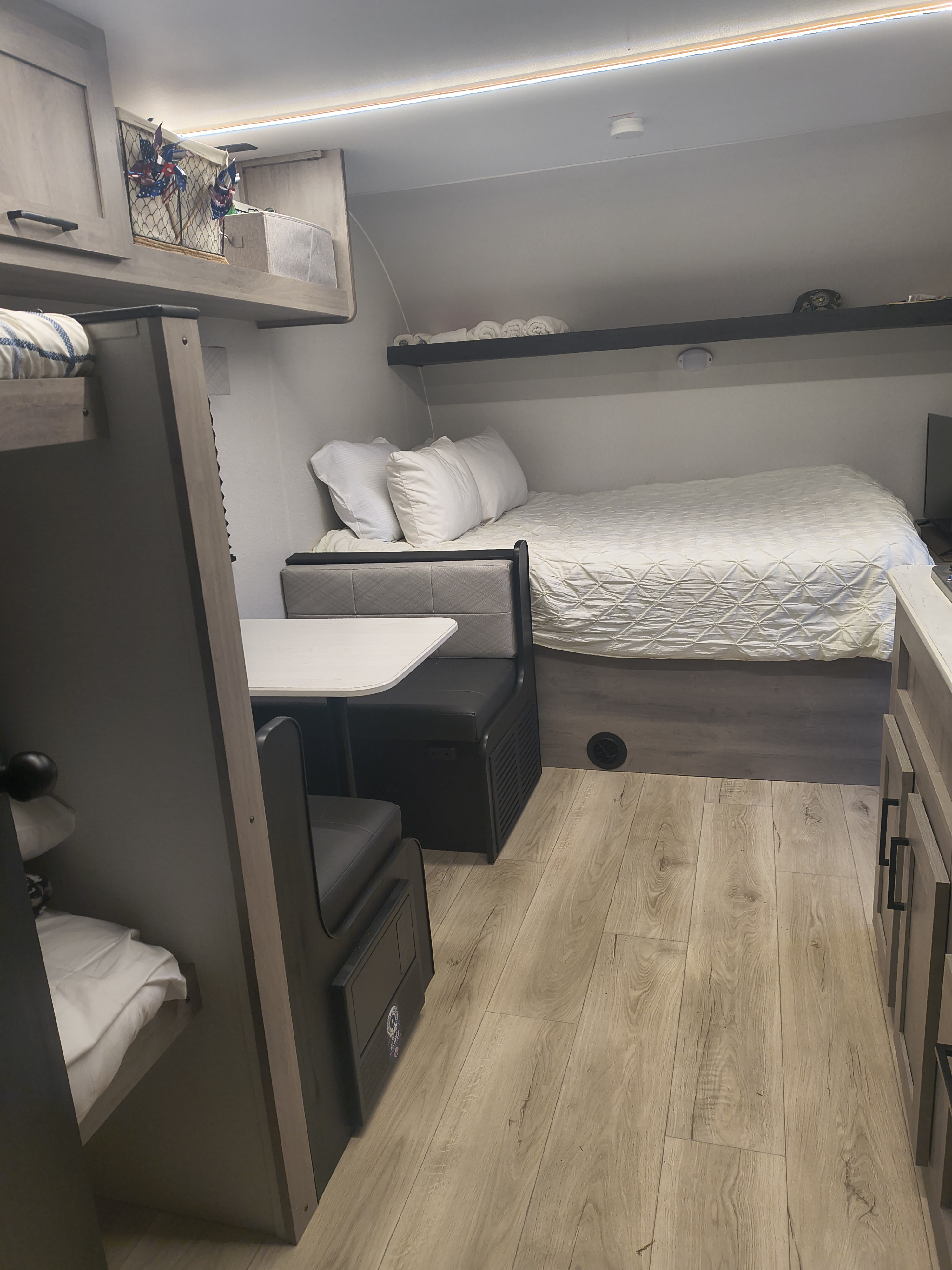 Cozy rv rental interior: main bed, bunks, and dining booth. Perfect for family travel & adventures.. Cruiser RV Embrace 2025
