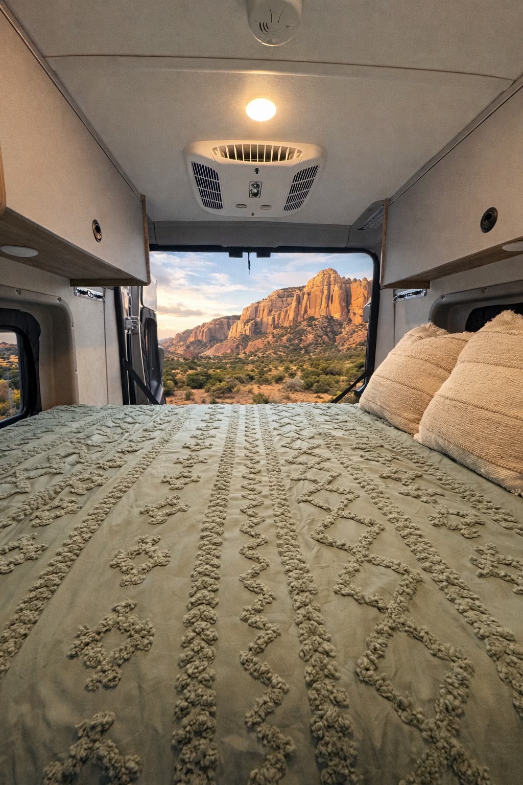 Cozy RV rental bedroom with a stunning mountain landscape view, offering a perfect escape for nature and van life adventures.. Winnebago Solis 2025