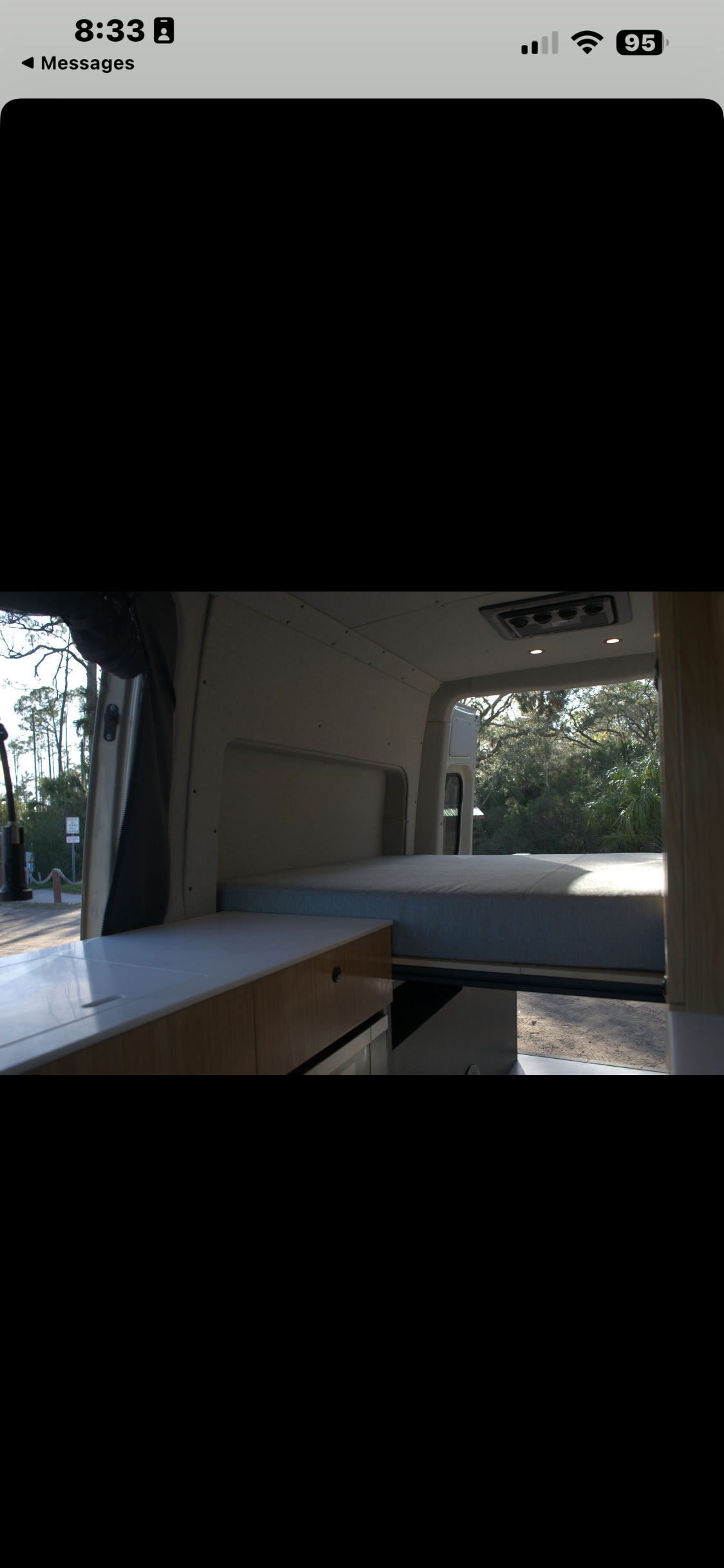RV rental interior: cozy bed, kitchenette, and nature views from the back of the van.. Mercedes Motorhome 2025