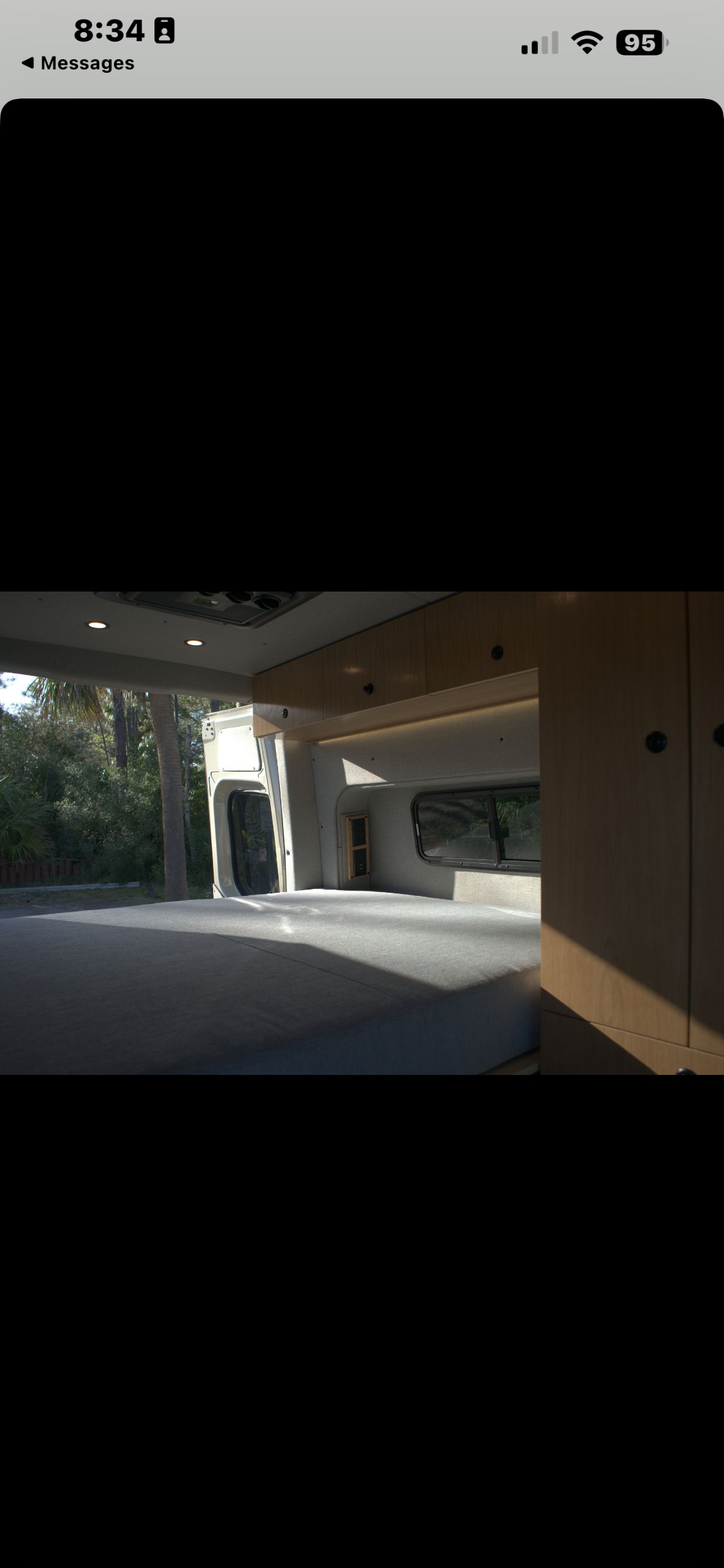 Modern RV rental interior with a comfortable bed, ample storage, and bright natural light for your next adventure.. Mercedes Motorhome 2025