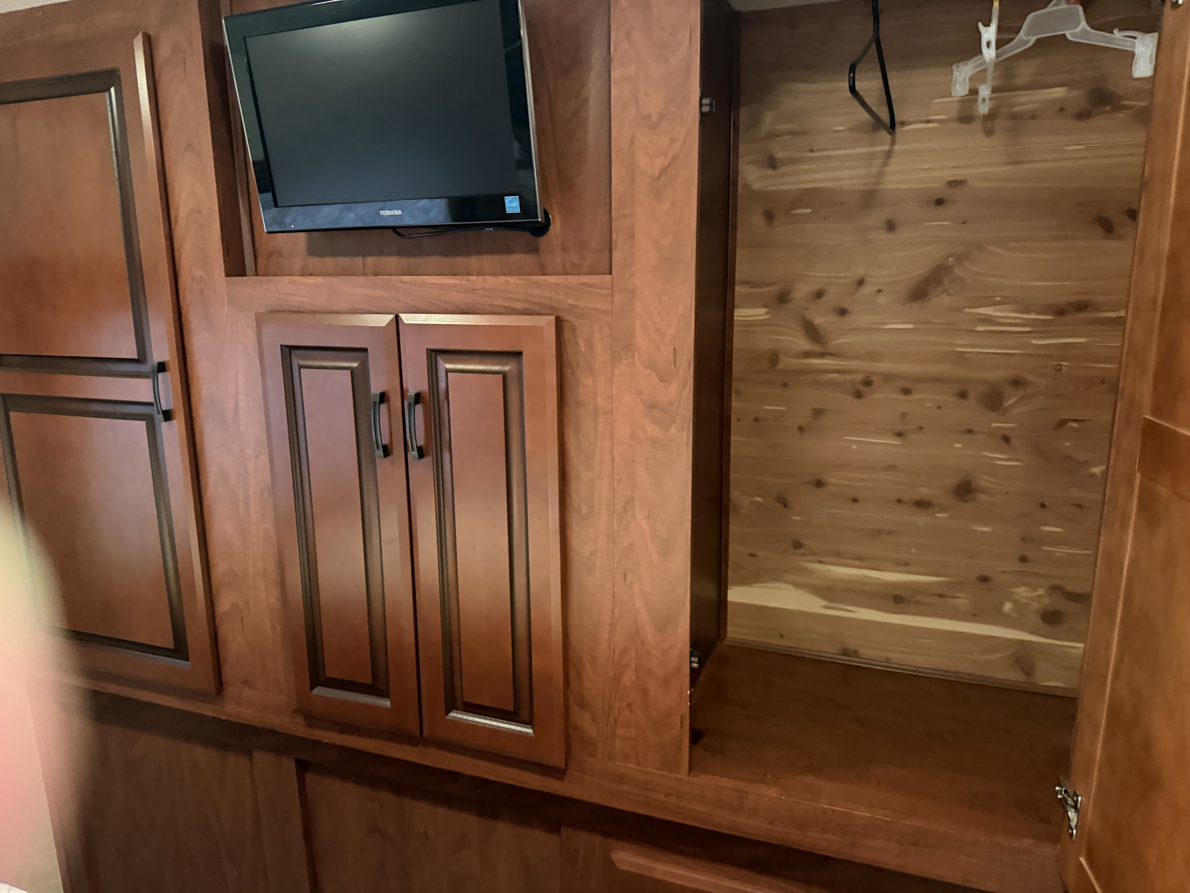 RV rental interior: Wooden TV nook with cabinets and a cedar closet for storage.. Forest River Forester 2013