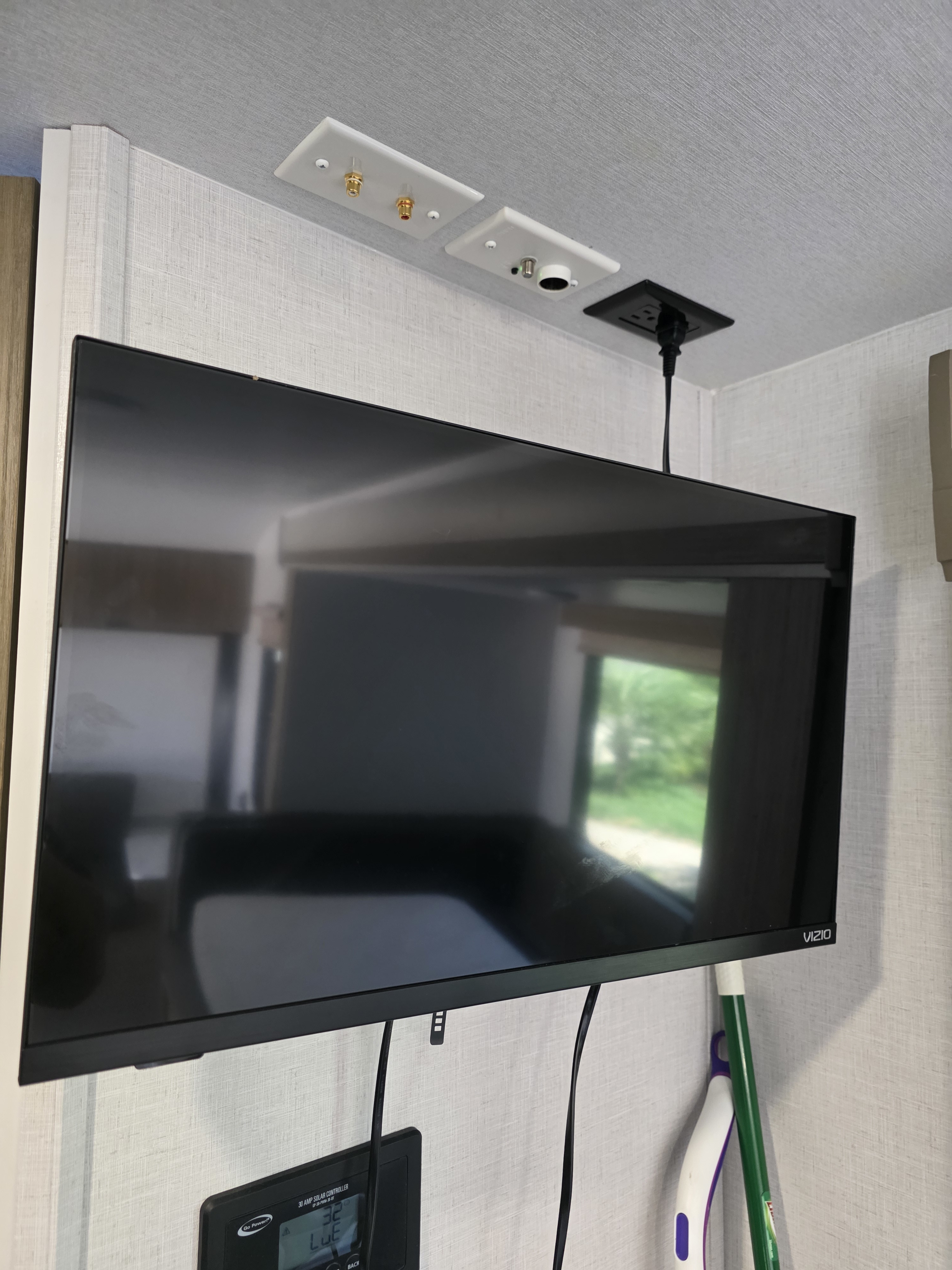 RV rental: Wall-mounted Vizio TV with power, audio, and antenna hookups above. Solar controller below.. Forest River FSX178BHSK 2025