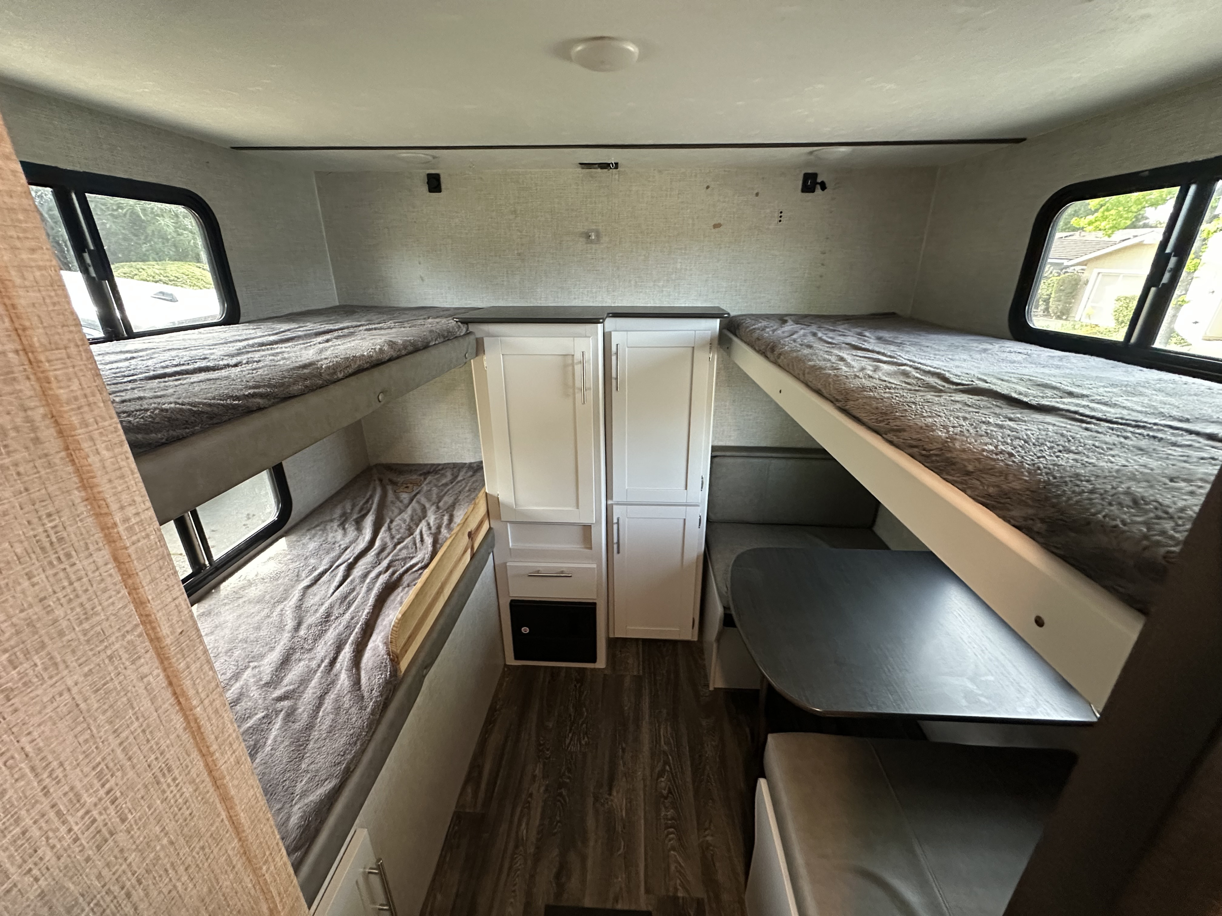Spacious RV rental interior with bunk beds, a dinette, and ample storage for comfortable travel.. Keystone RV Bullet Ultra Lite 2021