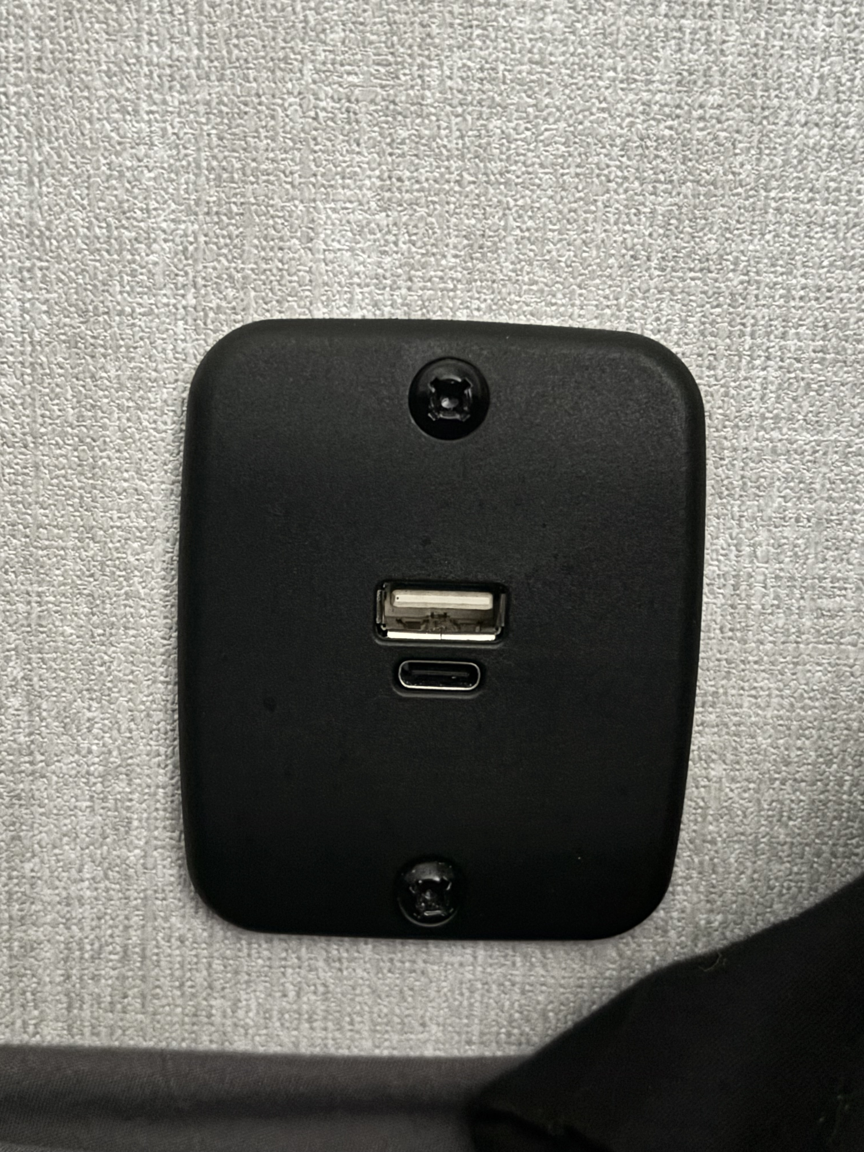 Black panel with USB-A and USB-C charging ports, secured to an RV rental wall. Ideal for charging mobile devices.. Forest River Viking 5K 2025