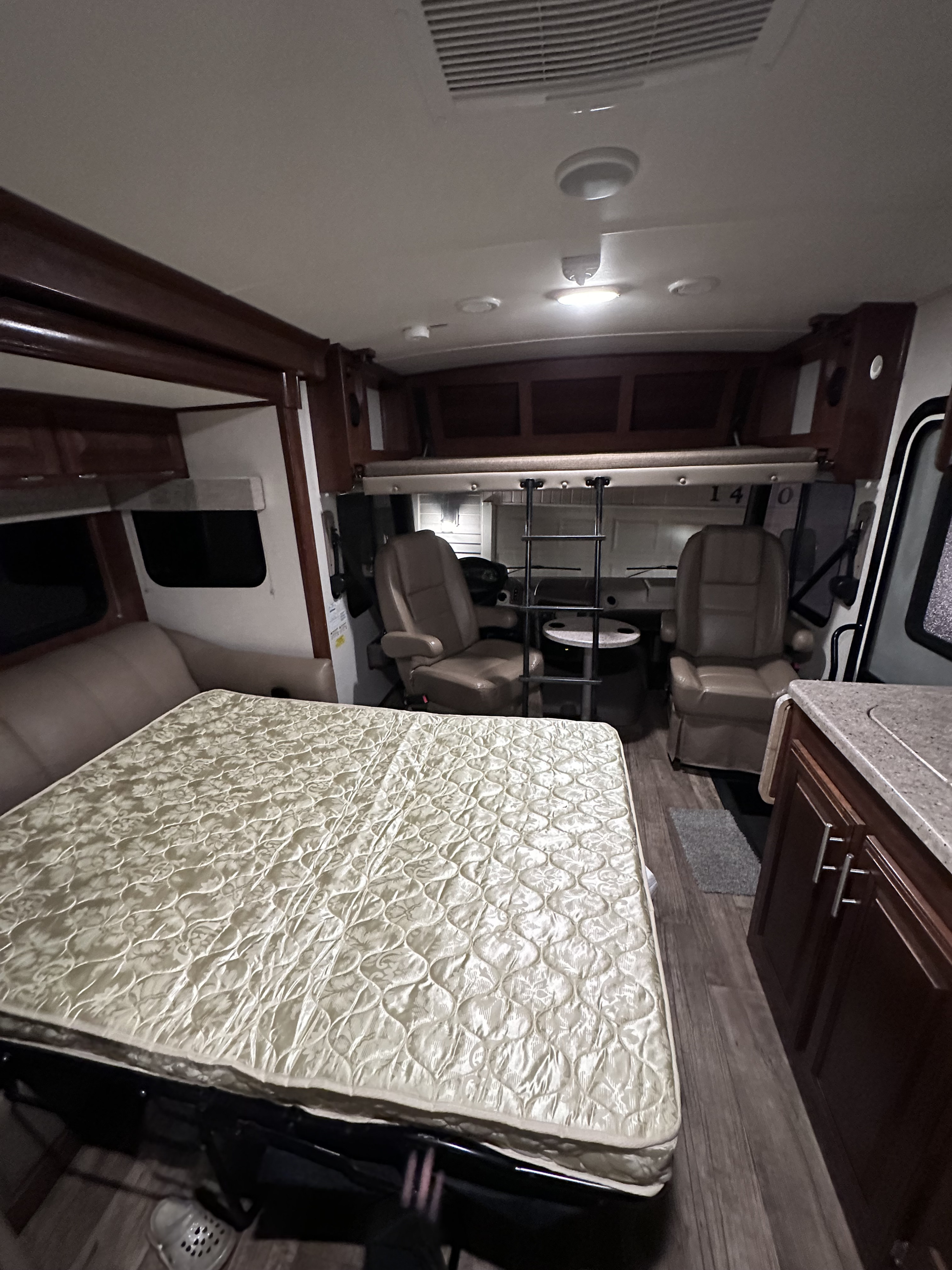 RV rental: spacious interior with a large bed, cockpit, sofa, overhead bunk, and kitchen counter.. Forest River FR3 2017