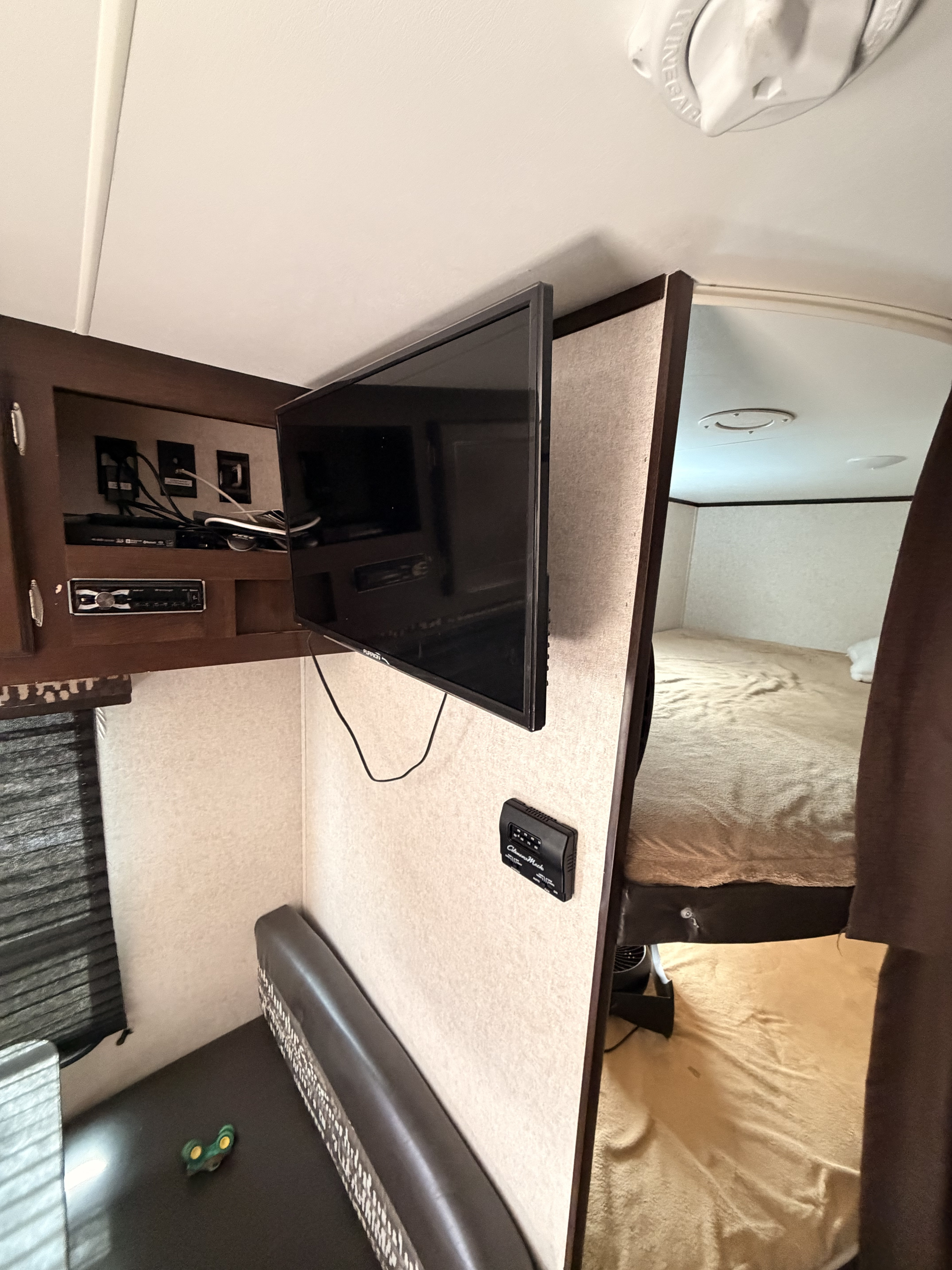 This RV rental's compact interior features a TV, stereo, dinette, and a glimpse into the bedroom for efficient living.. Jayco Jay Flight 2018