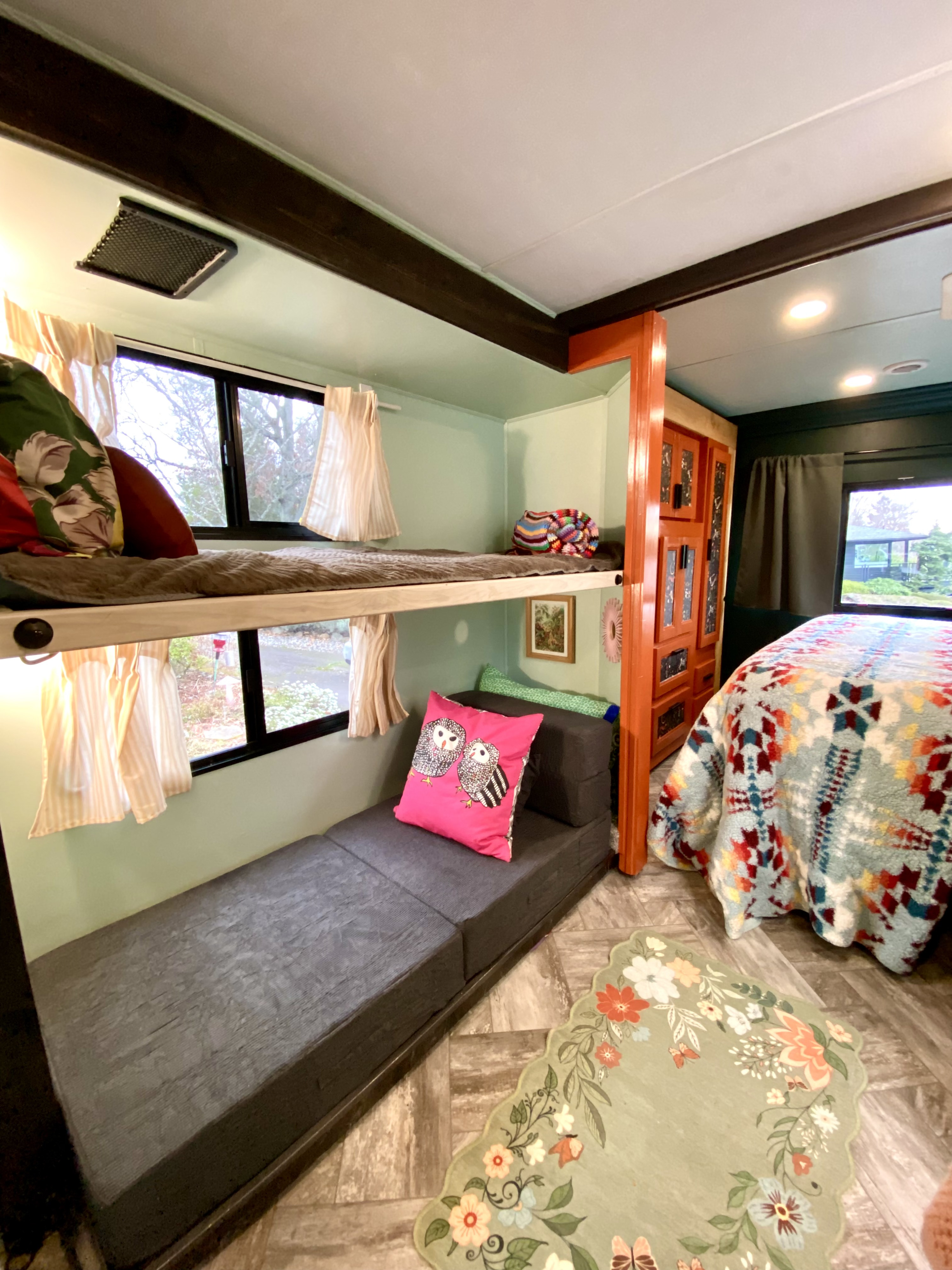 Inviting RV rental interior featuring cozy bunk beds, a main bed, and bright decor, ideal for family adventures.. Forest River Sunseeker LE 2022