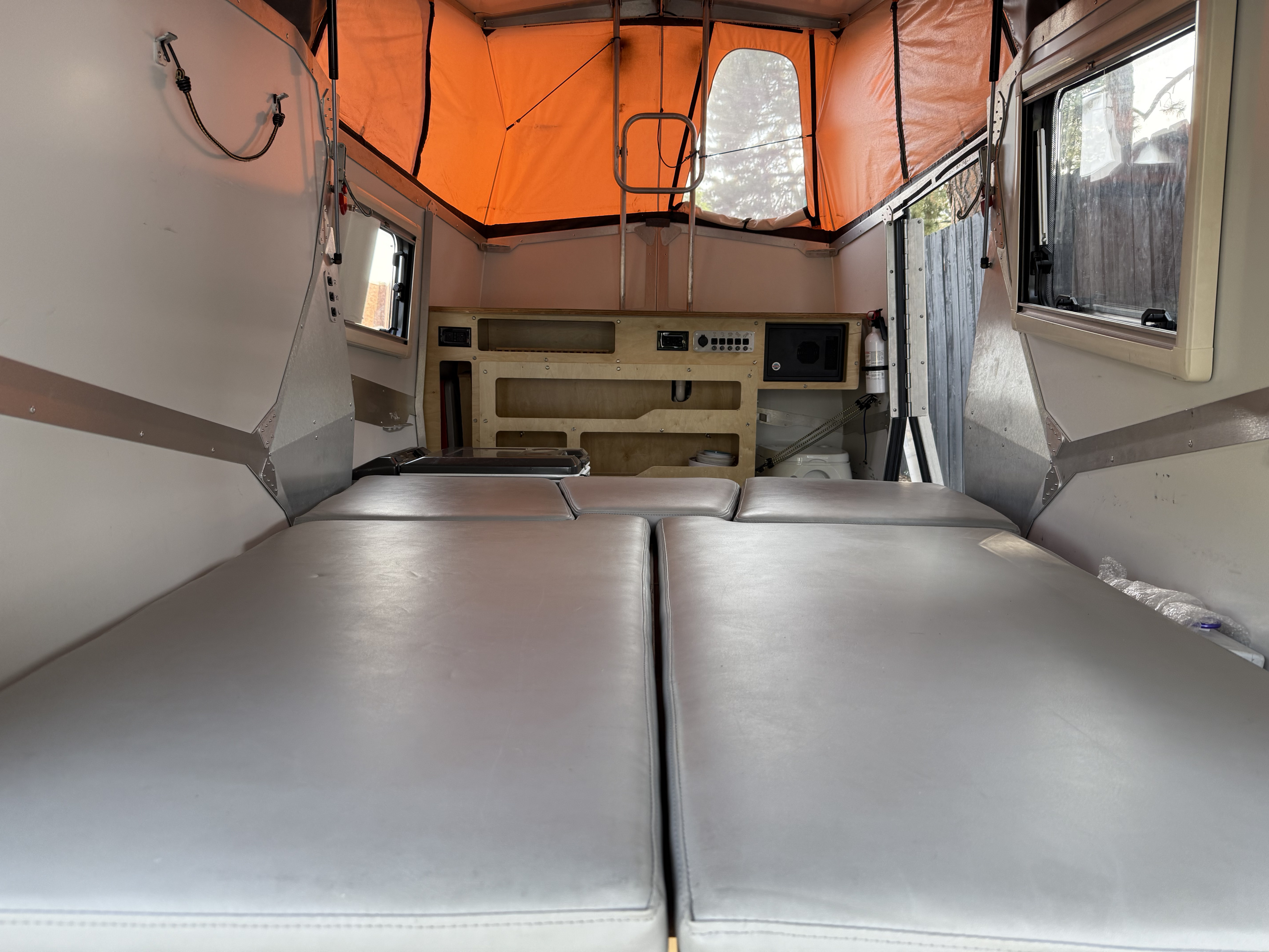 RV rental interior: cozy beds, pop-top tent, and smart storage. Ready for your next camping adventure!. TAXA TAXA Trailer 2016