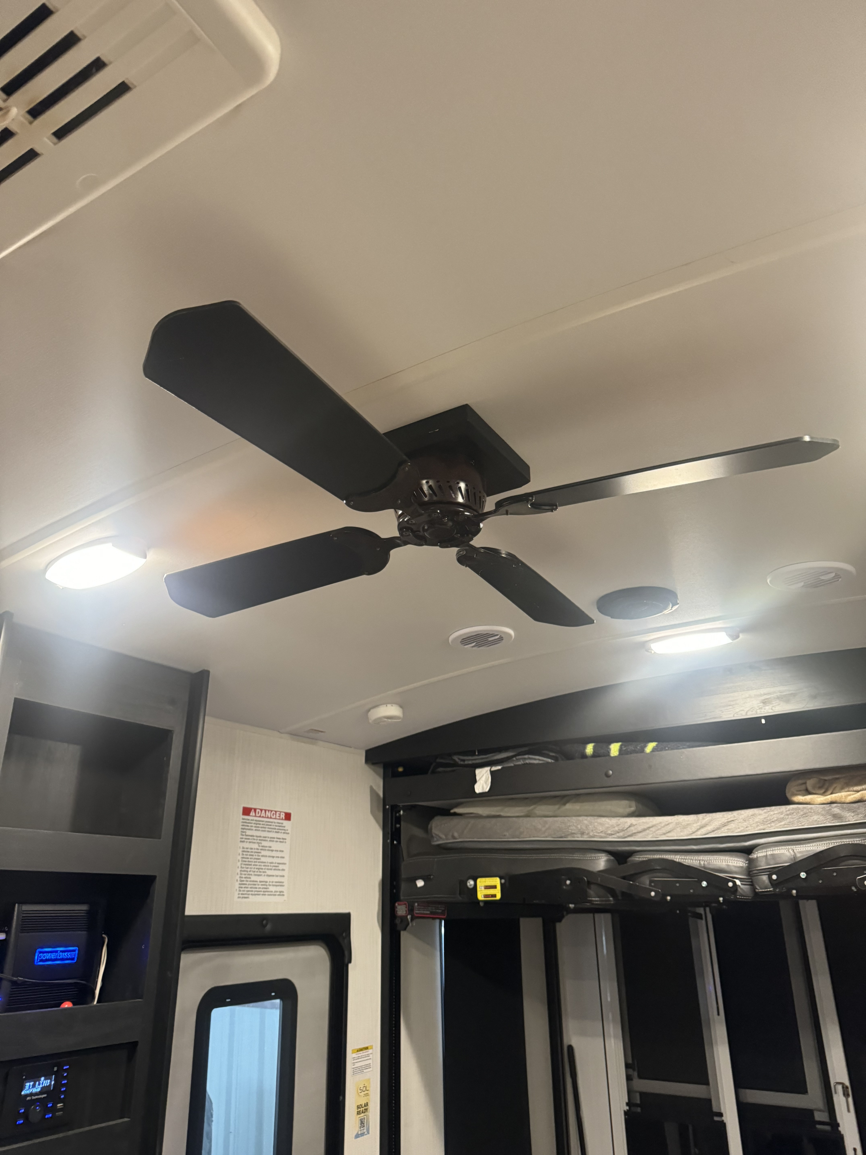 Inside an RV rental, a black ceiling fan, bright lights, and a bunk bed system enhance comfort and utility.. Cruiser Rv Corp Stryker 2024