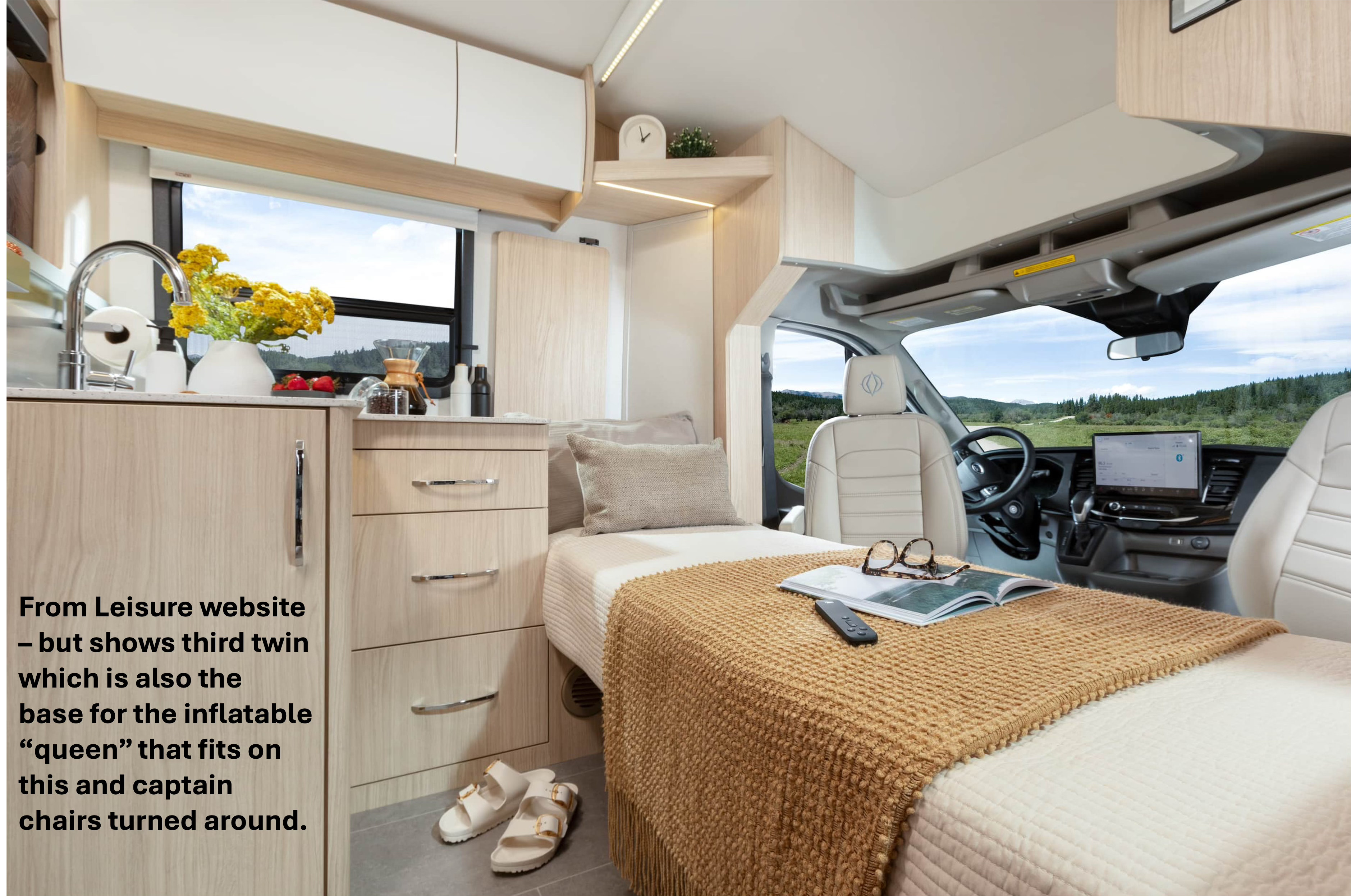 RV rental interior: a versatile twin bed that converts to an inflatable queen using turned captain chairs, beside a small kitchen.. Leisure Travel Van Wonder 24RTB 2025