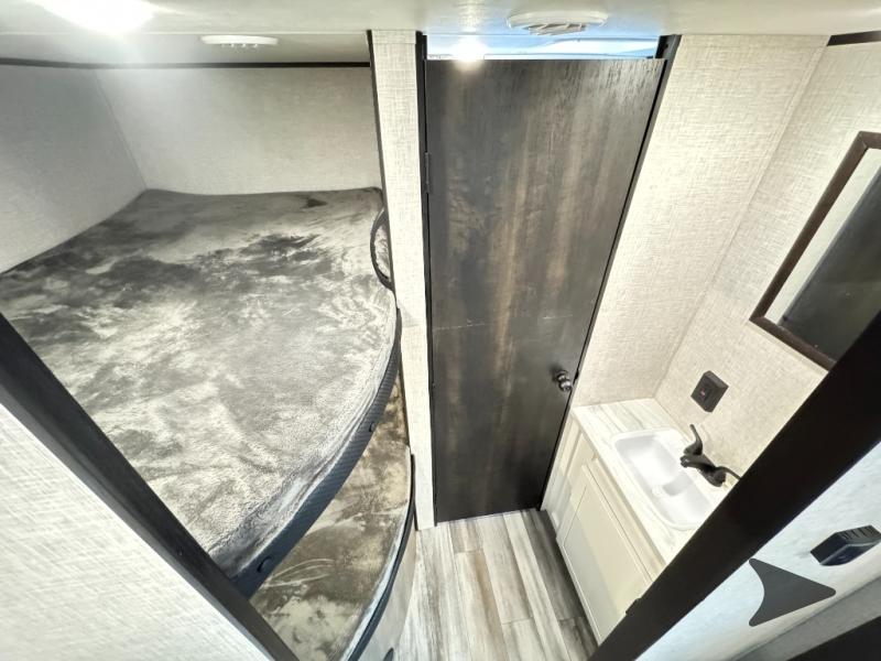 Inside this rv rental, find cozy bunk beds for sleeping and a compact bathroom with a sink and mirror.. Jayco Jay Flight SLX 2024
