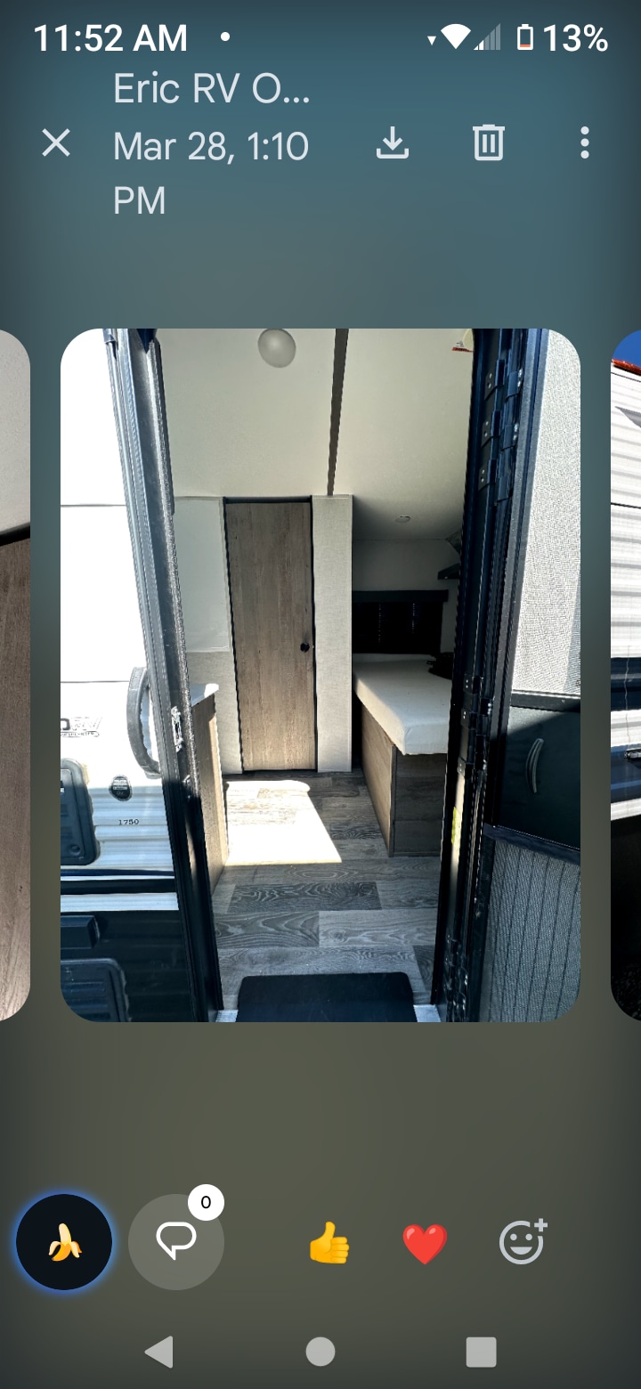 Interior of an rv rental, seen from the entry door. Features a bed, closet, and laminate flooring. Perfect for your next trip!. Keystone RV Springdale 2021