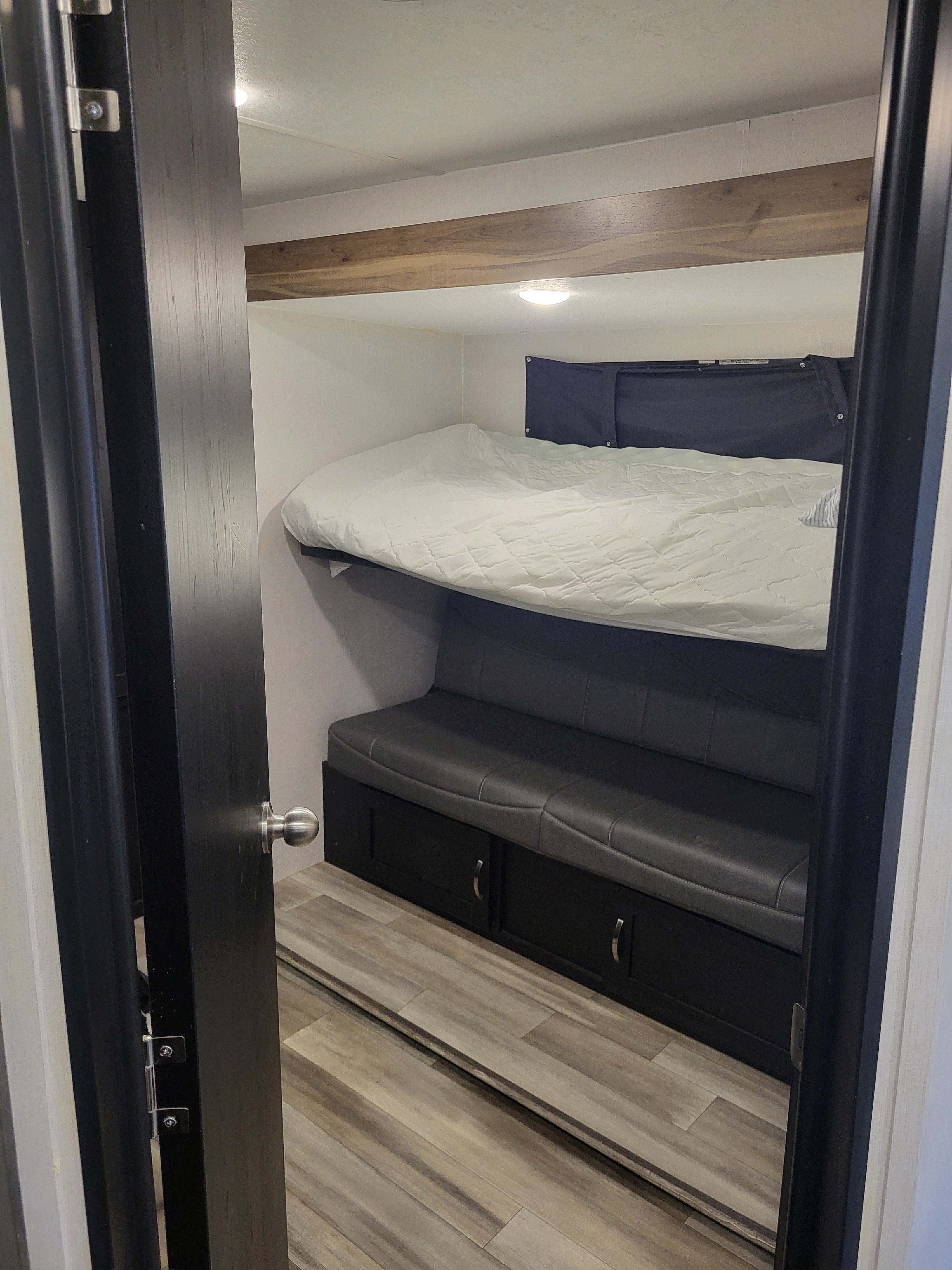 This RV rental offers a compact bunk bed setup with a comfy upper bed, convertible seating below, and integrated storage.. Coachmen Freedom Express liberty edition 326bhdsle 2023