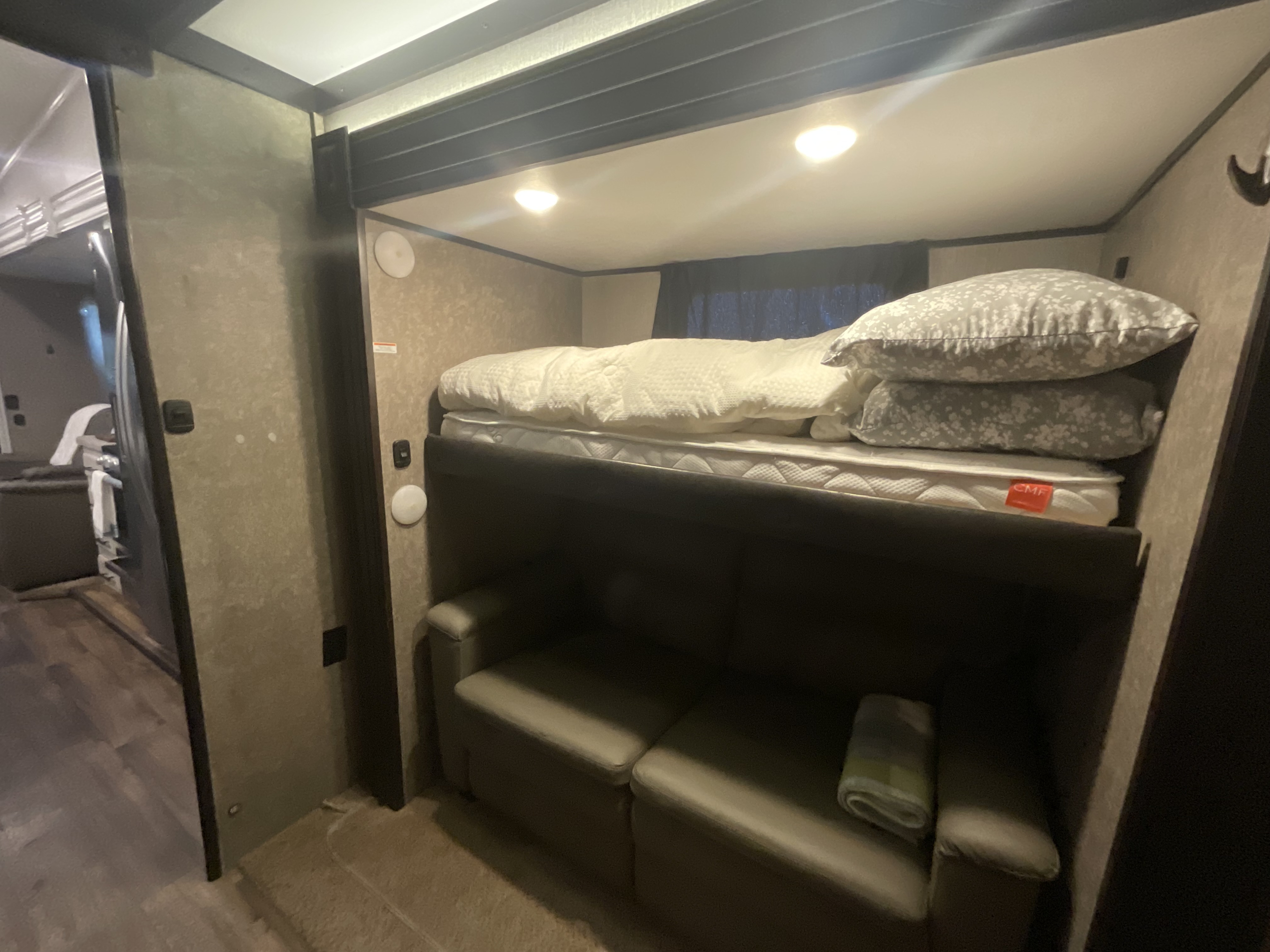 Cozy bunk beds and a convertible sofa in this RV rental, providing comfortable sleeping and seating for your adventures.. Jayco Eagle 2020