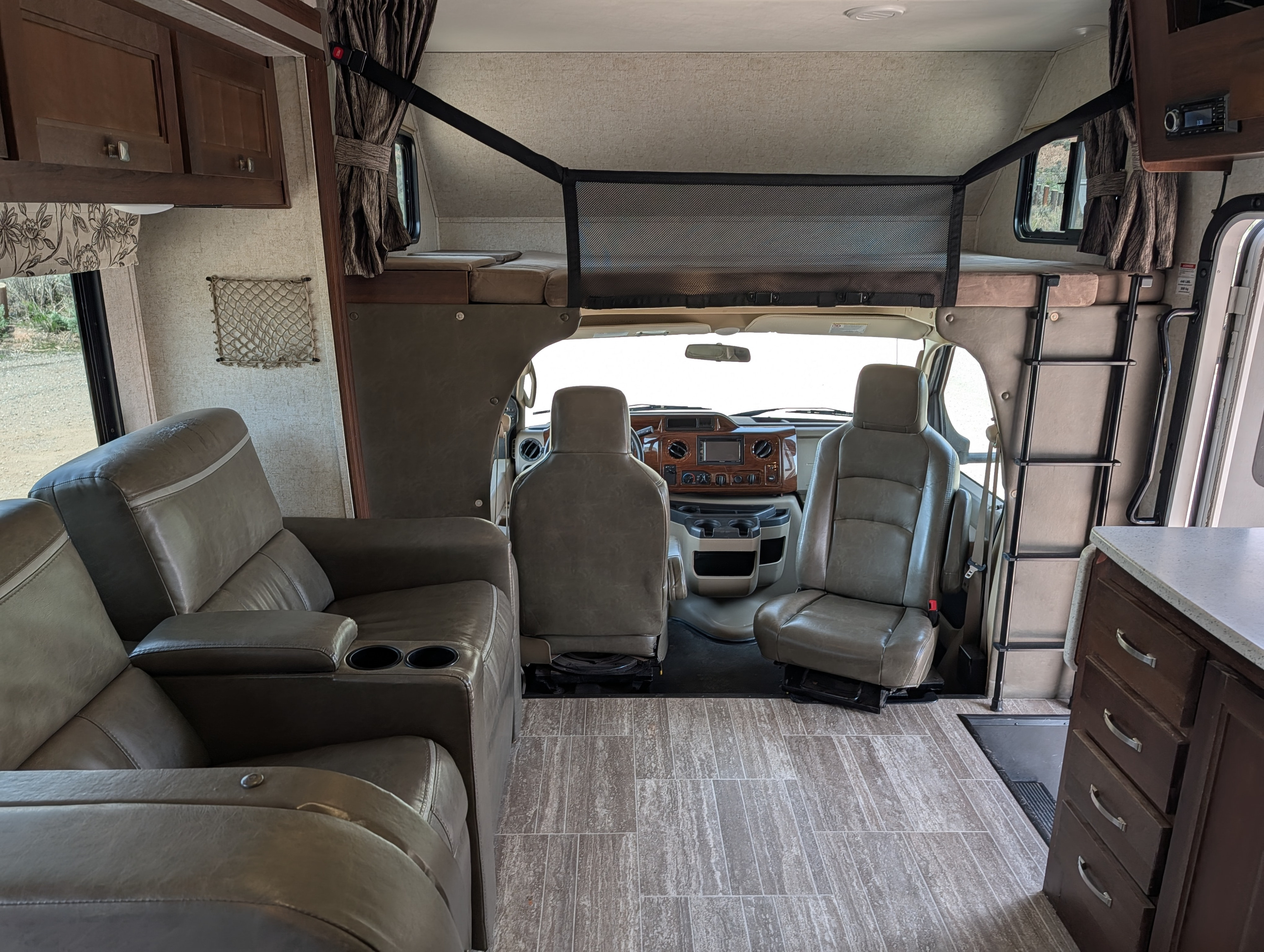 RV rental interior showcasing the cab-over bed, cockpit with captain's chairs, and a comfortable living area with recliners.. Forester Forester Motorhome 2018