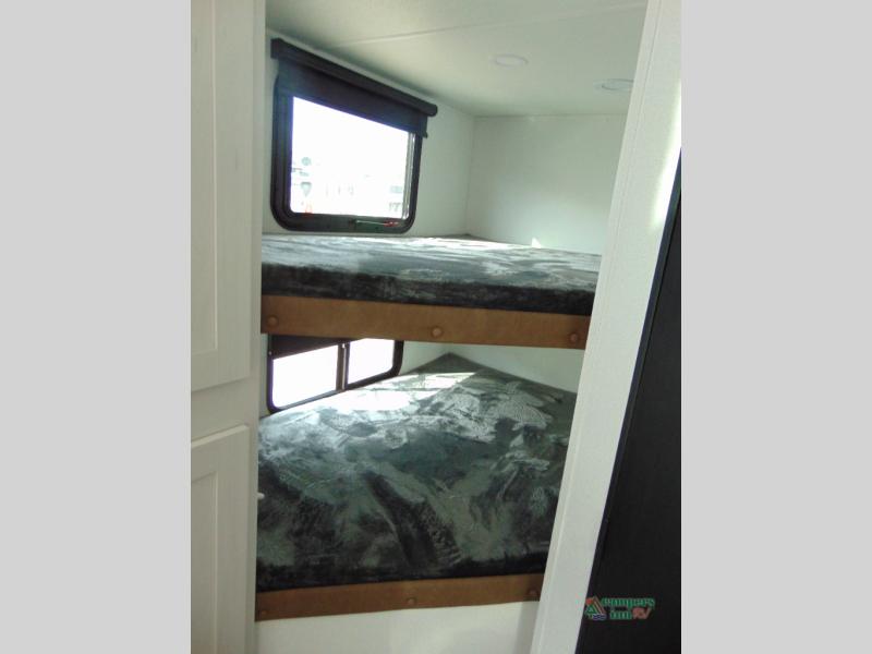 Cozy **RV rental** interior featuring two bunk beds with windows for comfortable sleeping accommodations.. Forest River Palomino Puma 2026