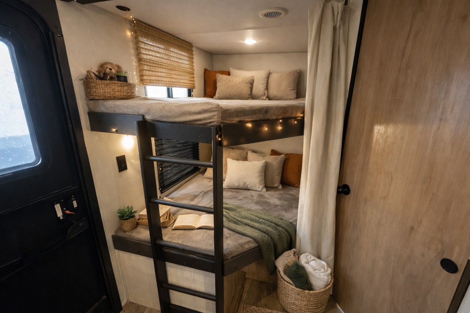 Inviting RV rental bunk beds, decorated with string lights & pillows, offer a cozy sleeping nook. Features an open book on bottom bunk.. Forest River Campsite Reserve 2025