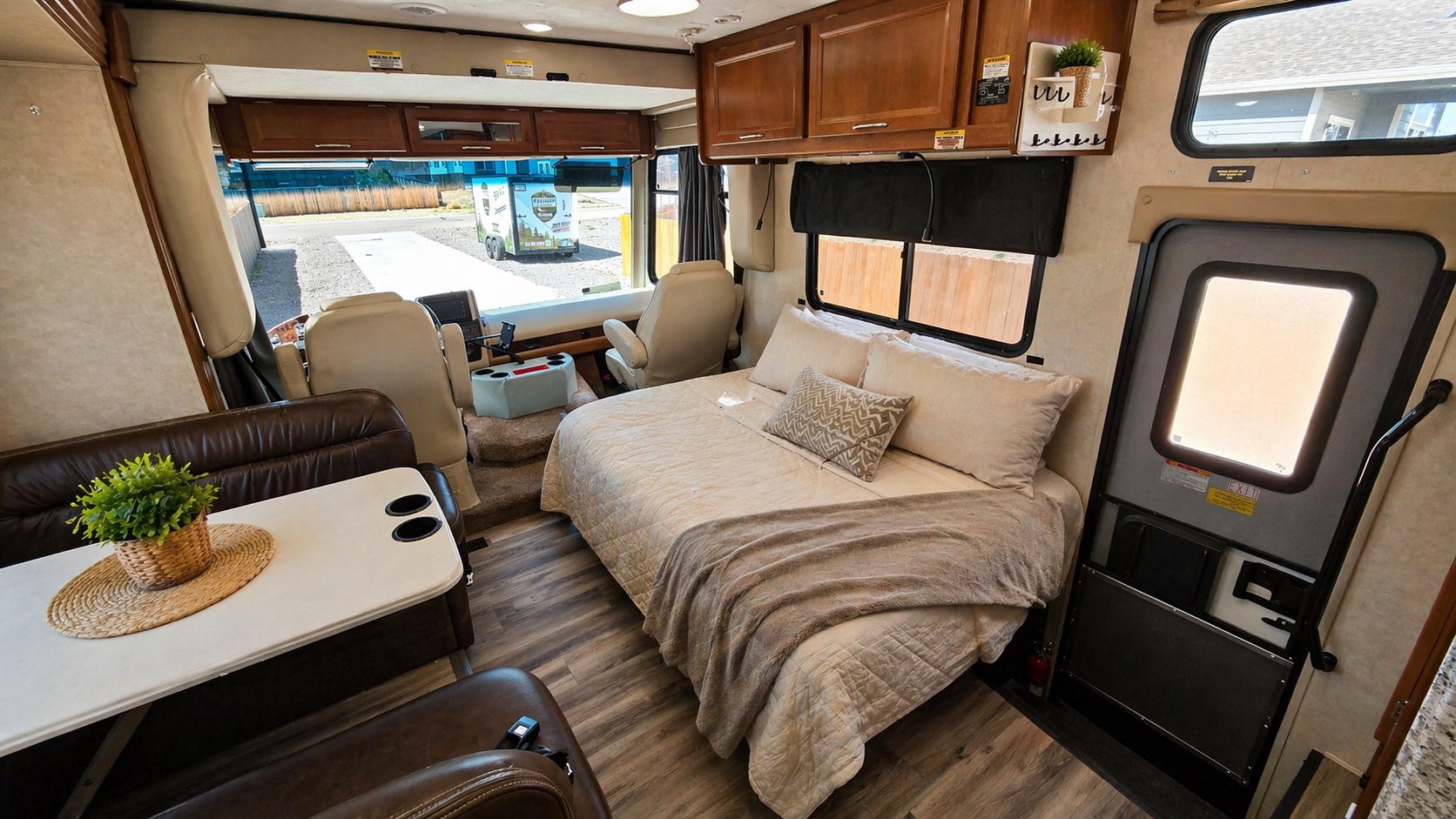 Explore this clean & spacious RV rental interior, featuring a comfy bed, dining area, and driver's cabin for your next trip.. Coachmen Pursuit 2014