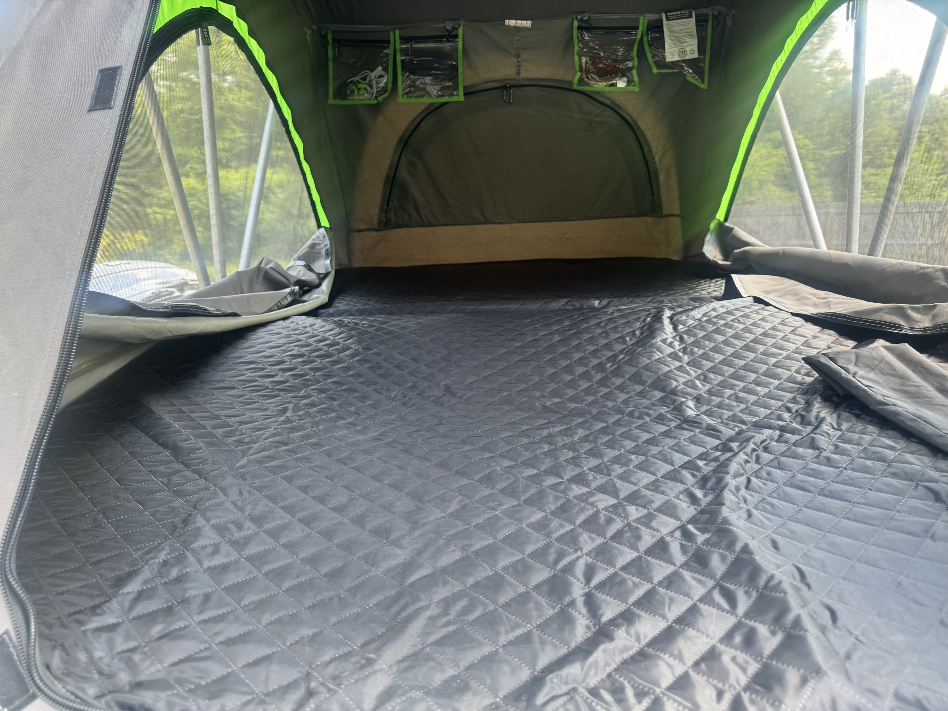 Experience comfortable camping with this RV rental tent interior, featuring a quilted sleeping mat and mesh windows.. Jeep Patriot 2016