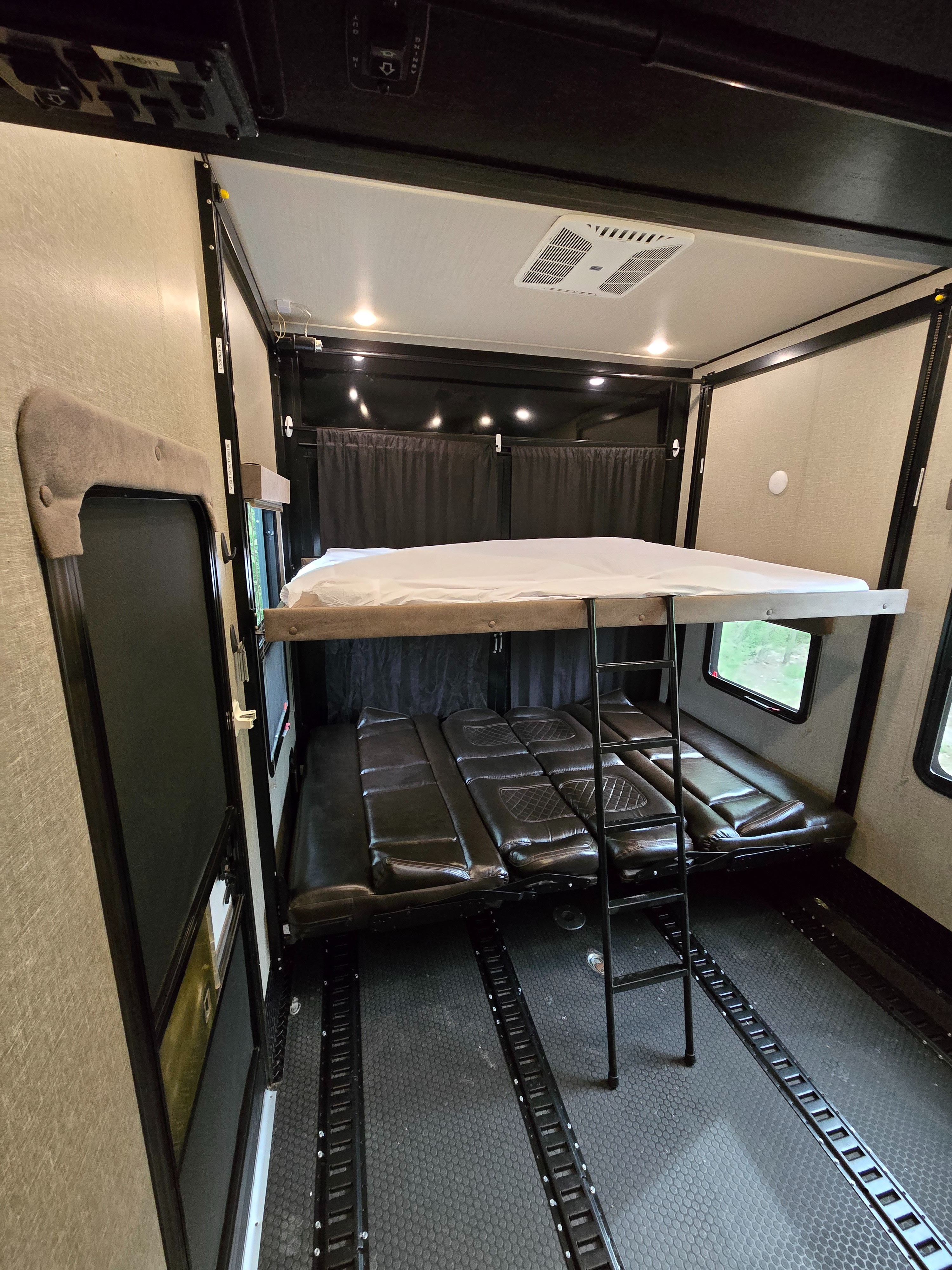 Inside this rv rental, a toy hauler's convertible bunk beds and tough E-track floor offer adaptable sleeping & cargo space.. Grand Design Momentum 2019
