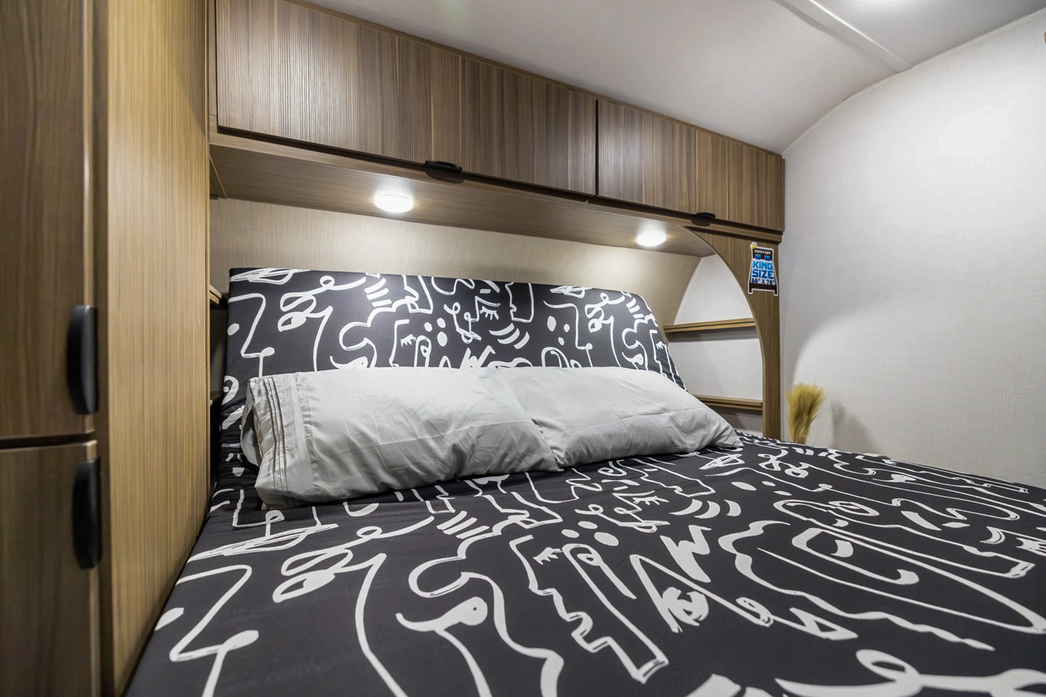 This RV rental offers a comfy bedroom with a custom king-size bed, stylish bedding, and overhead storage for your travels.. Forest River Salem 2025