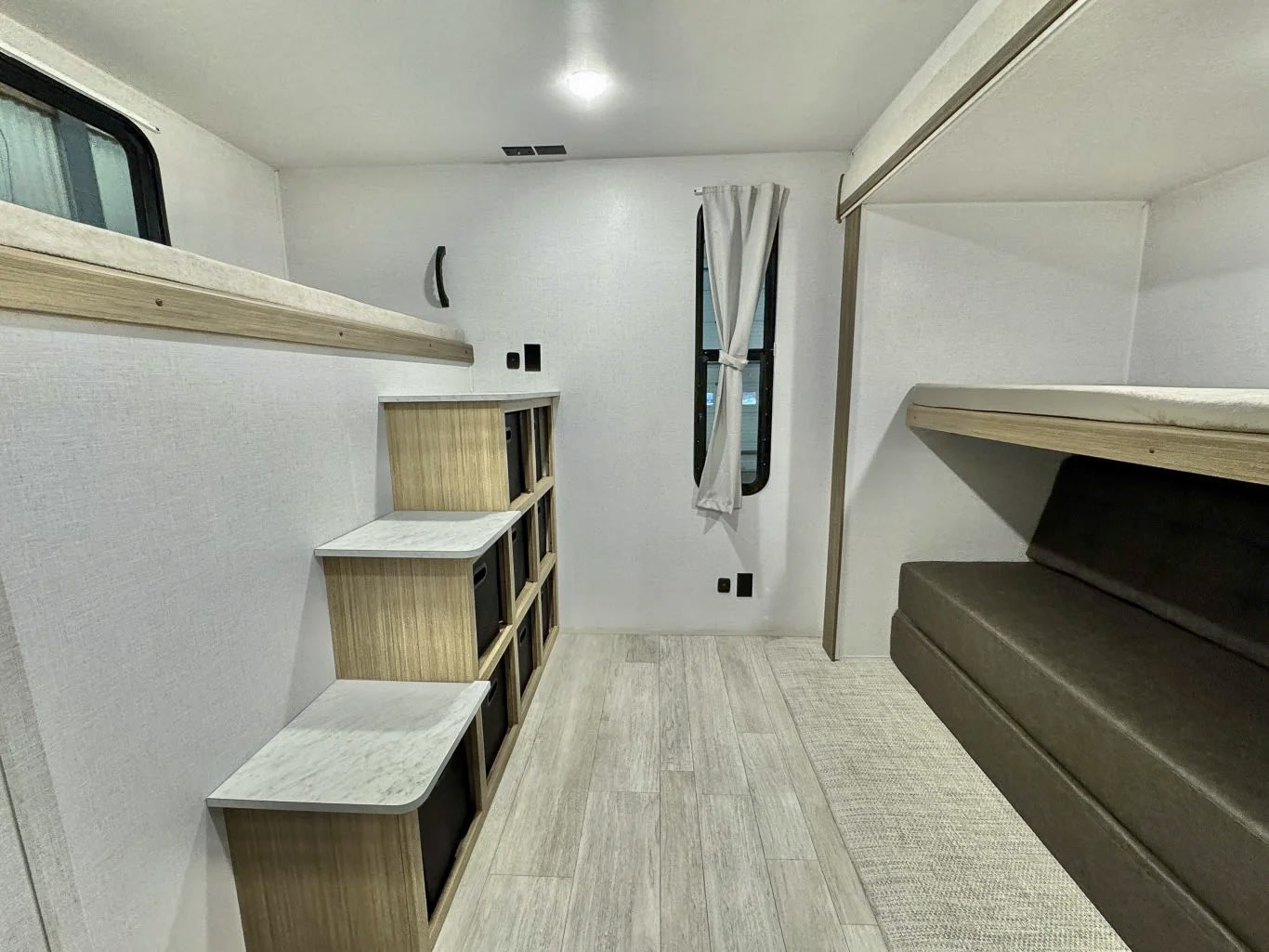 Spacious RV rental bunkhouse area with stepped storage and comfy sleeping, ideal for road trips.. Forest River Salem 2025
