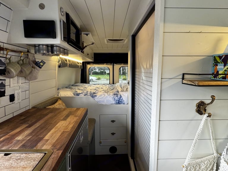 Step inside this RV rental's cozy interior, featuring a compact kitchen, comfy bed, & clever storage for adventures.. Dodge Other 2023