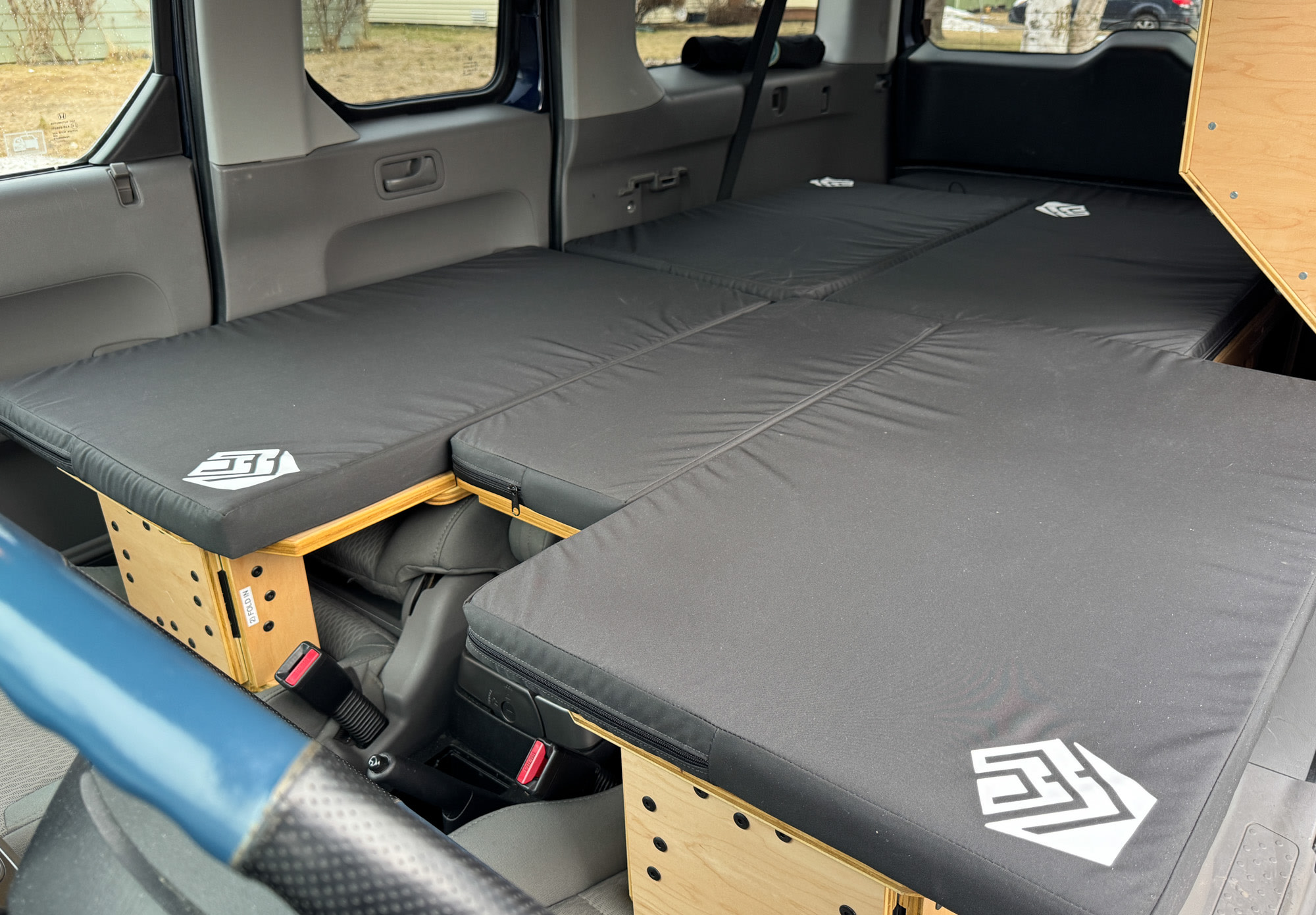 Honda Element camper bed conversion for comfortable car camping or an RV rental alternative. Black mattresses, wooden supports.. Honda Element 2010