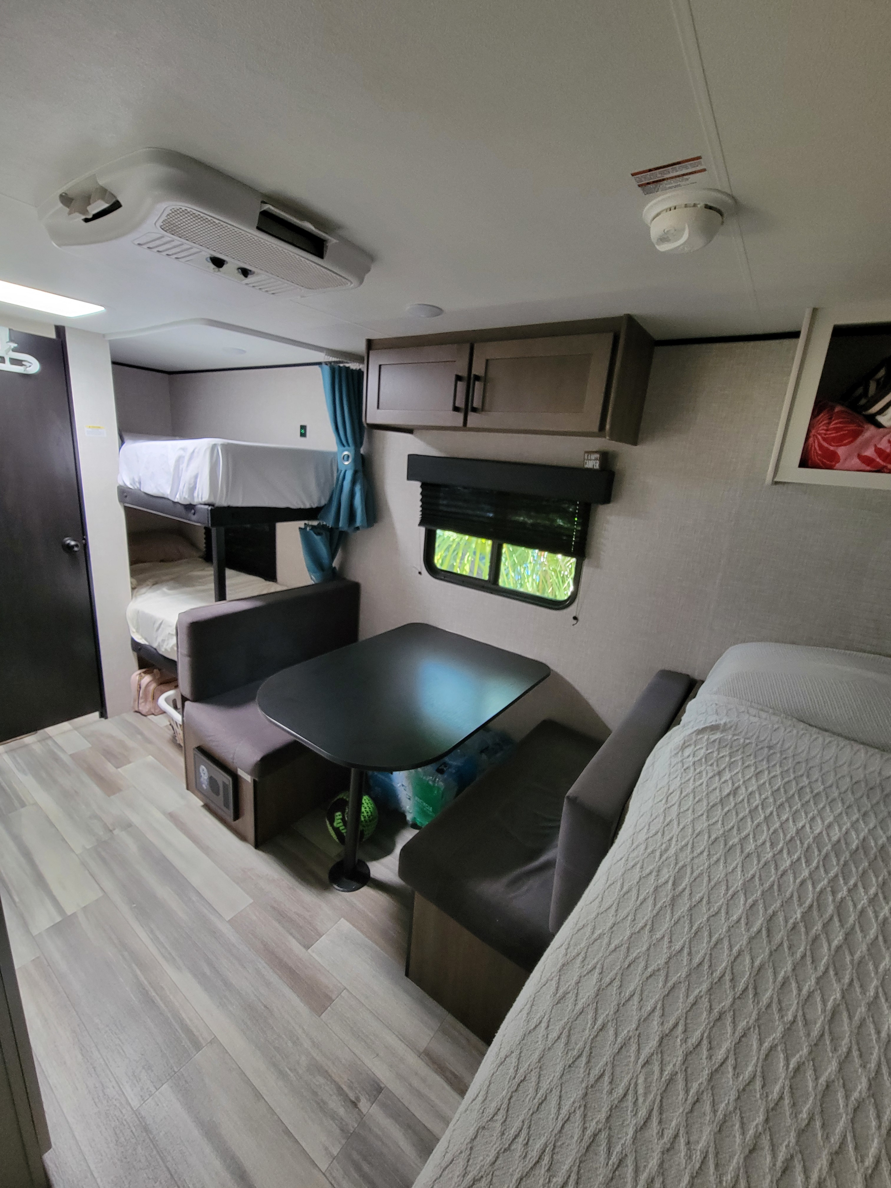 Compact rv rental interior with bunk beds, dinette, and main sleeping area, showcasing the versatile living space.. Jayco Jay Flight SLX 2025