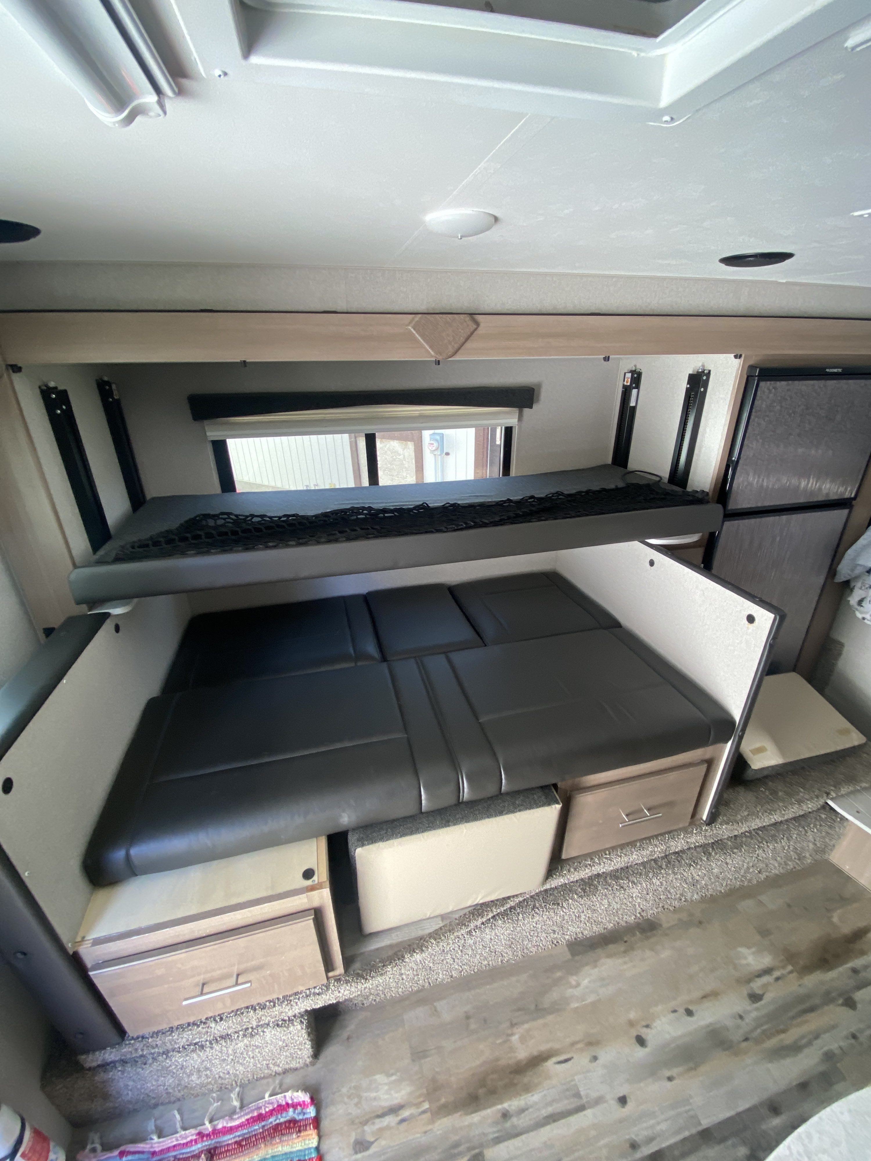 RV rental interior: bunk beds with a convertible lower seating area and storage, offering smart space in a compact camper.. Ford Ford F-350 2020