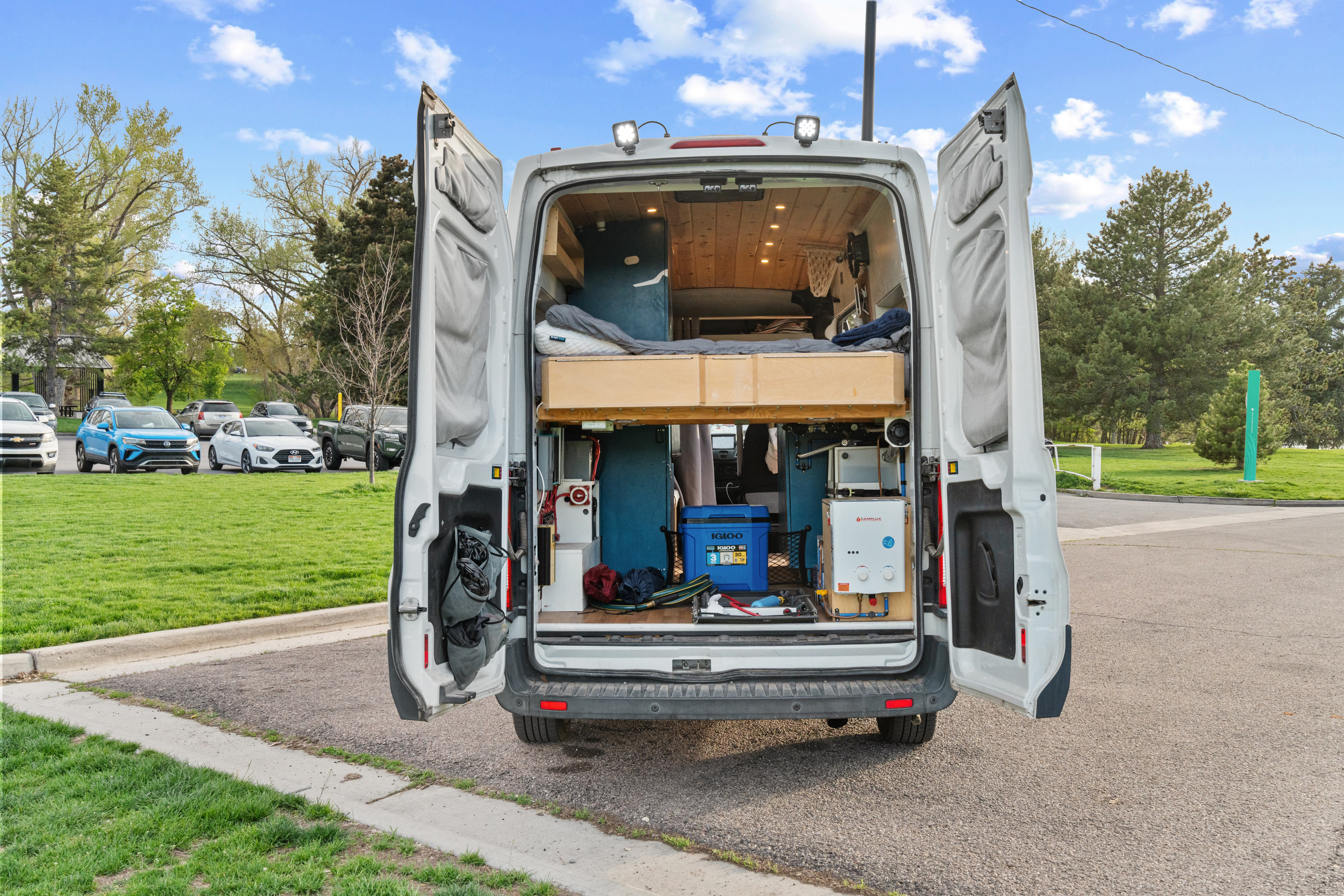 RV rental camper van interior revealed: custom bed, storage, and water heater for off-grid adventures.. Ford Transit Custom 2017