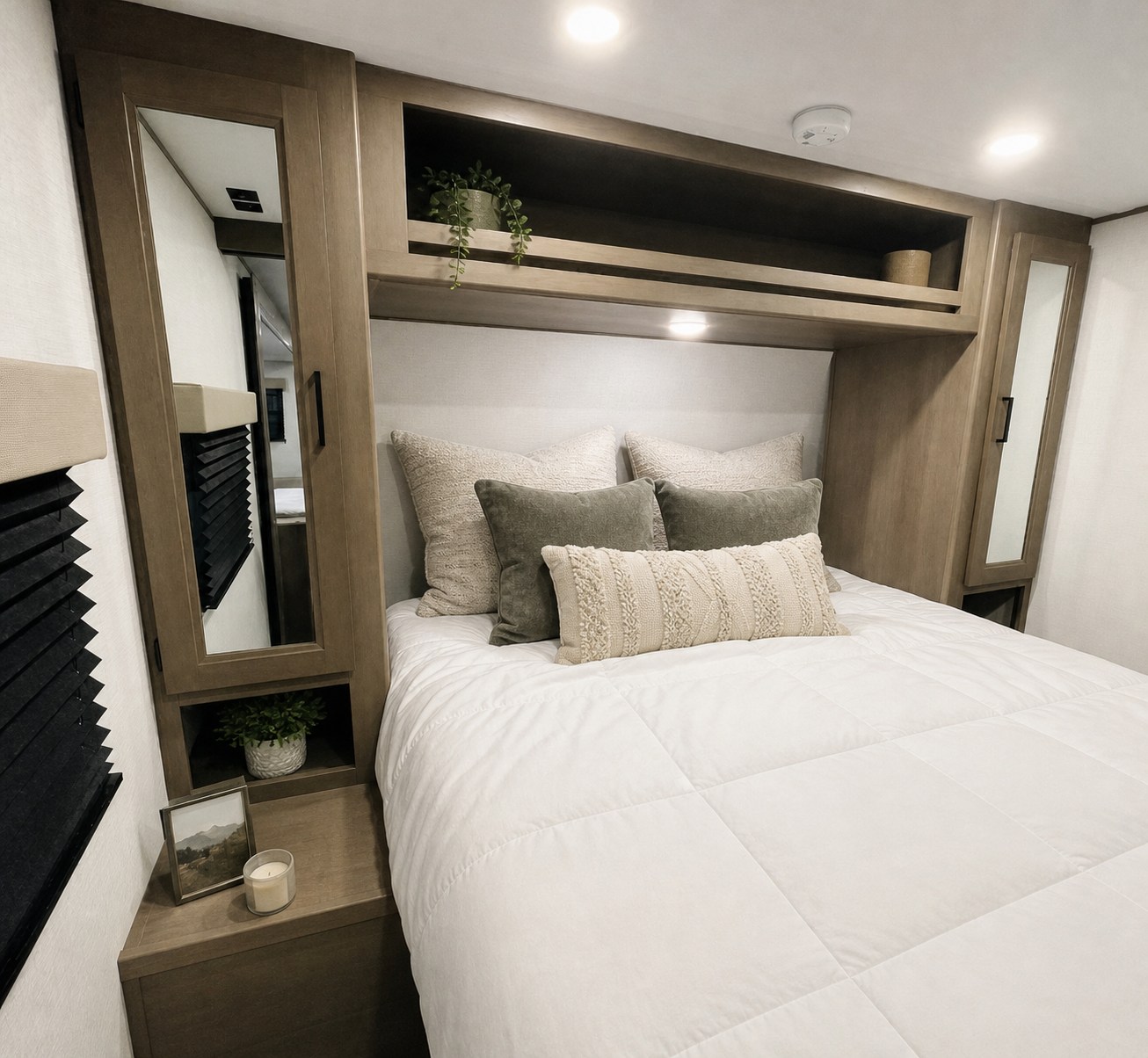 Cozy RV rental bedroom featuring neutral decor, comfortable bedding, and smart built-in storage. Ideal for a relaxing travel experience.. Grand Design Transcend Xplor 2026