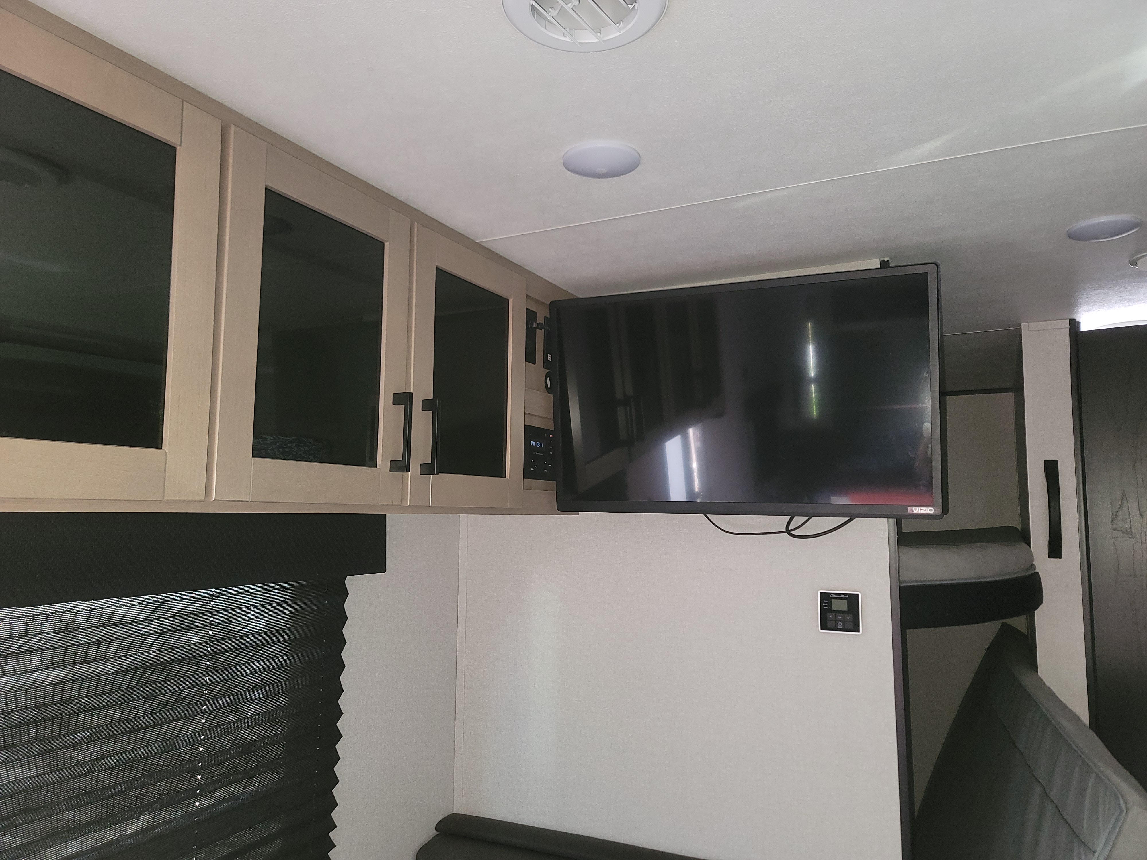 RV rental interior featuring overhead cabinets, a mounted TV, and bunk beds. Ideal for family trips.. Jayco 260BH 2026