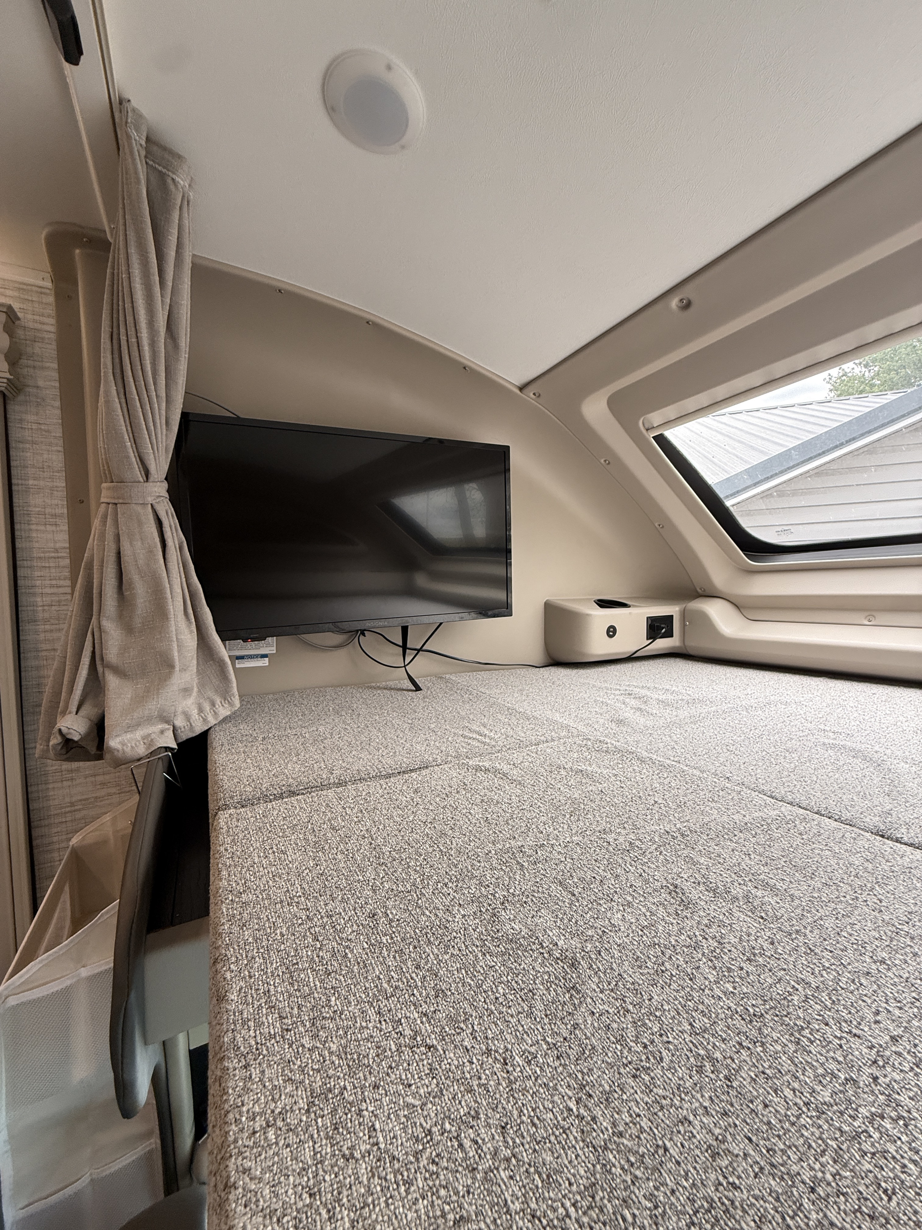 This RV rental offers a cozy bunk bed sleeping area with a TV, window, and convenient charging ports.. Entegra Coach Odyssey 2024