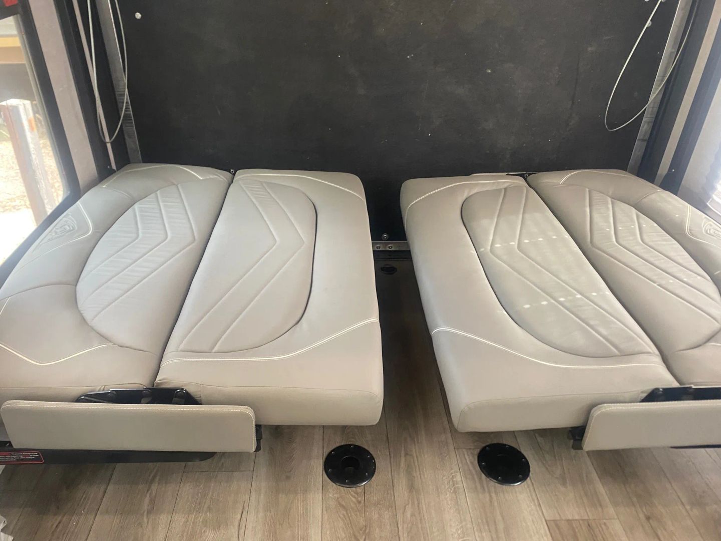 RV rental: Gray upholstered convertible seating/beds with geometric stitching against a dark wall and wood-look floor.. Eclipse Recreational Vehicles Attitude 2022