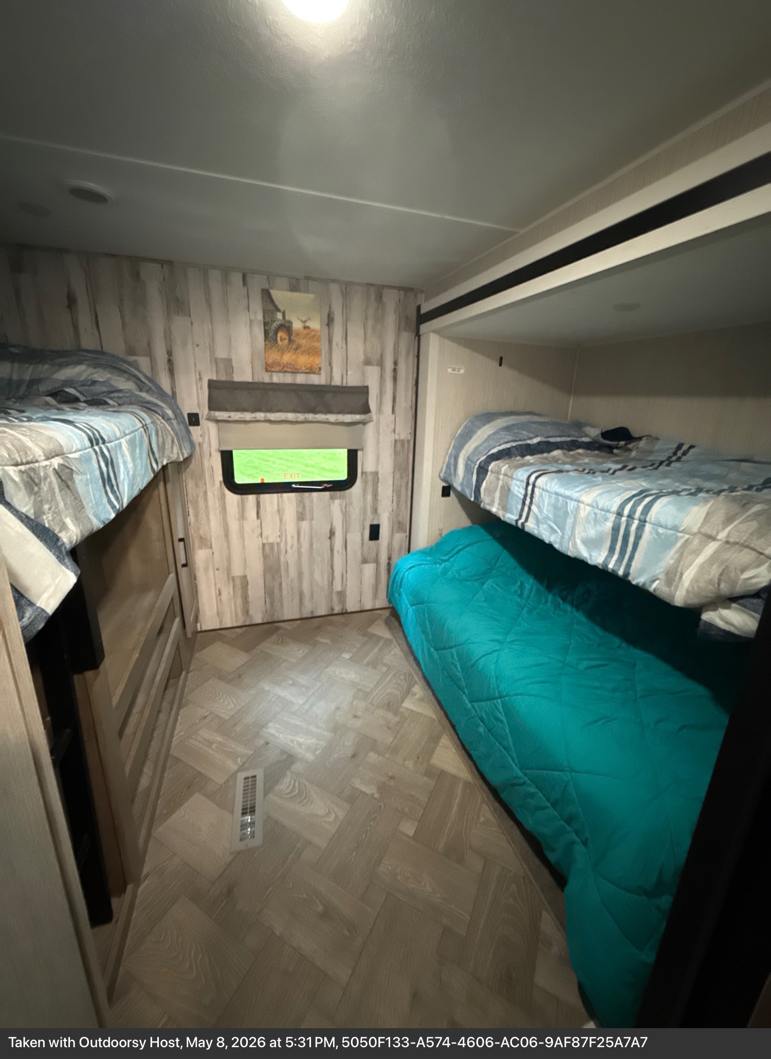 Compact RV rental bunk room, featuring cozy bunk beds with striped bedding and a light wood-look interior.. Forest River Palomino Puma 2022