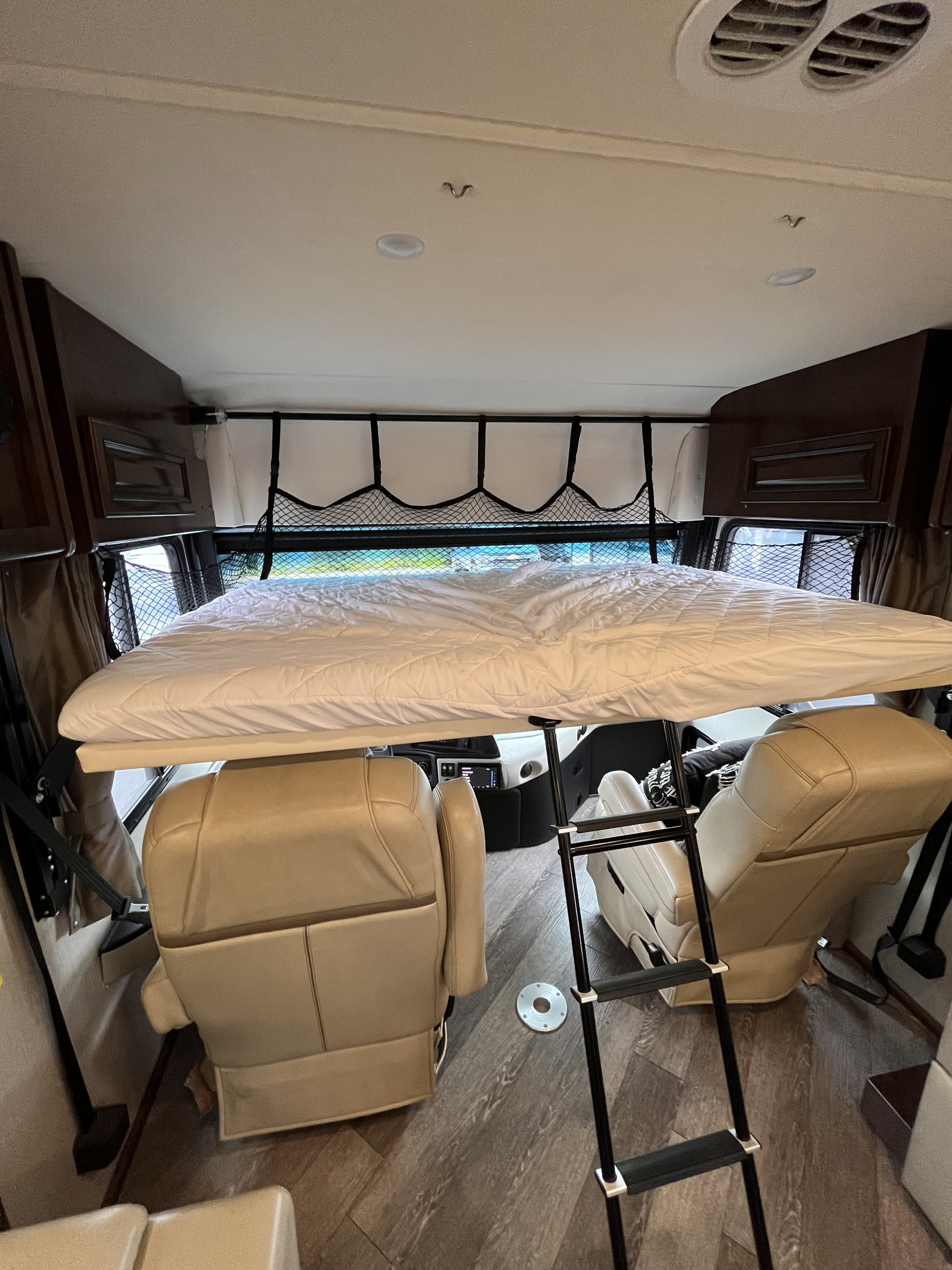 Overhead bunk bed with ladder in an RV rental, offering extra sleeping above the cab seats. Perfect for families on the road.. Fleetwood Pace Arrow 2020