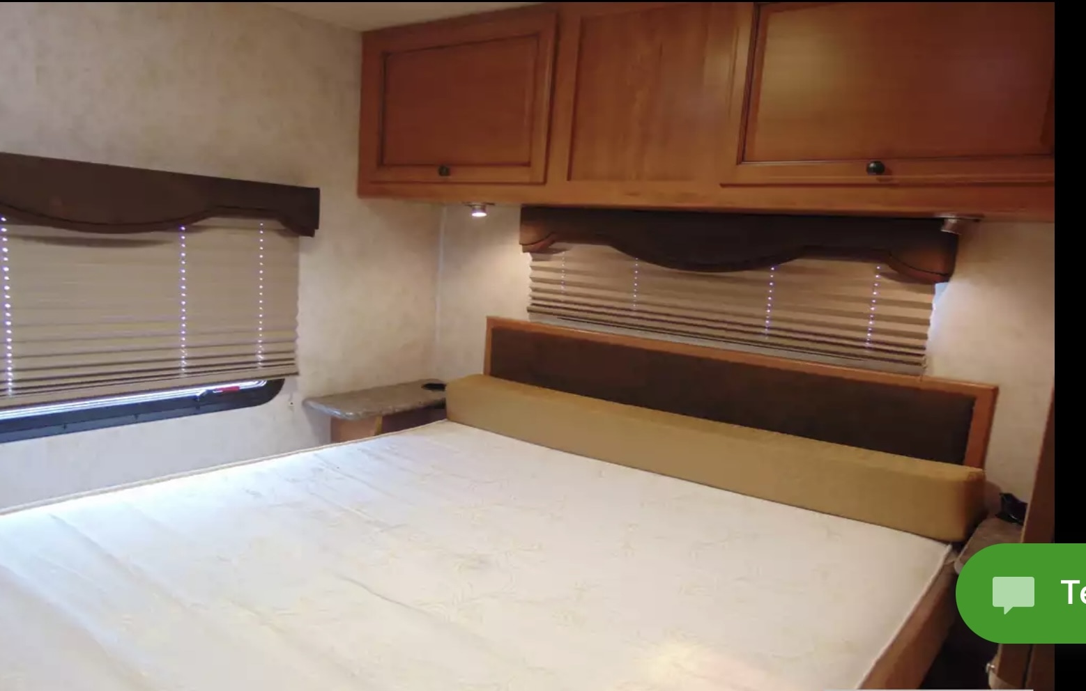 RV rental bedroom interior with a cozy bed, overhead cabinets, and window blinds, perfect for travel comfort.. Tioga Ranger 2012