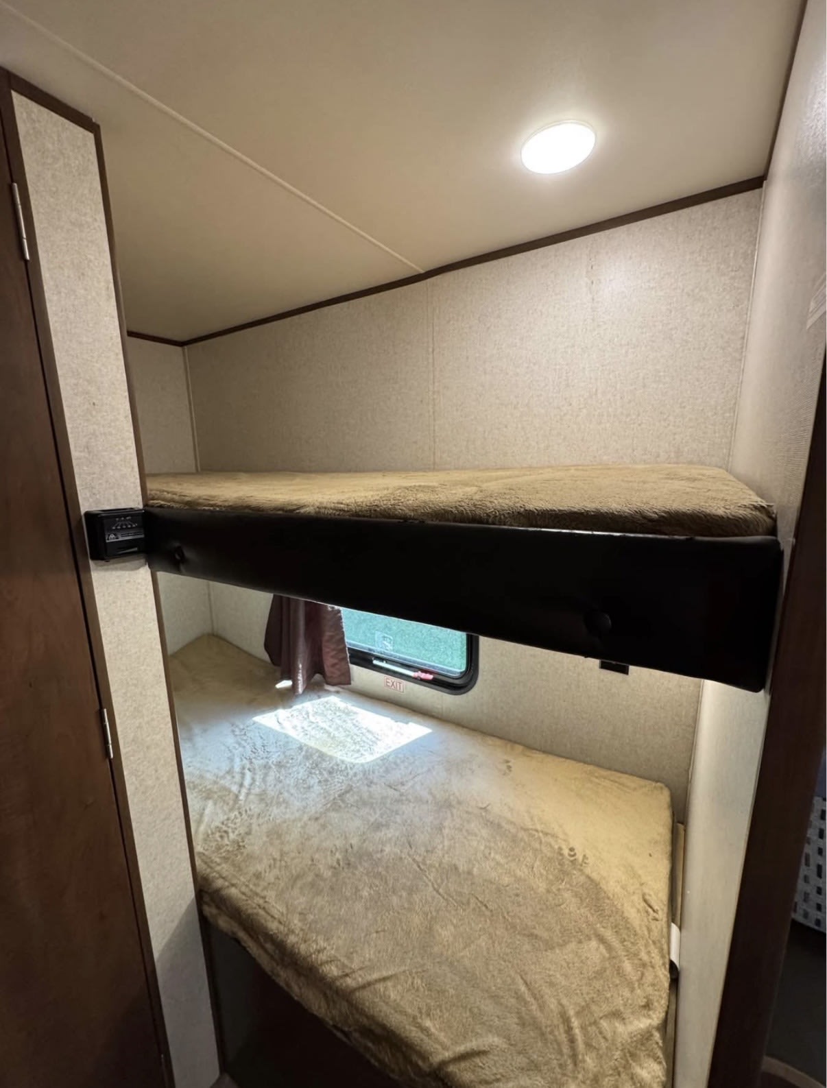 RV rental interior features cozy bunk beds with soft bedding, a ceiling light, and an exit window below.. Jayco Jay Flight SLX 2017