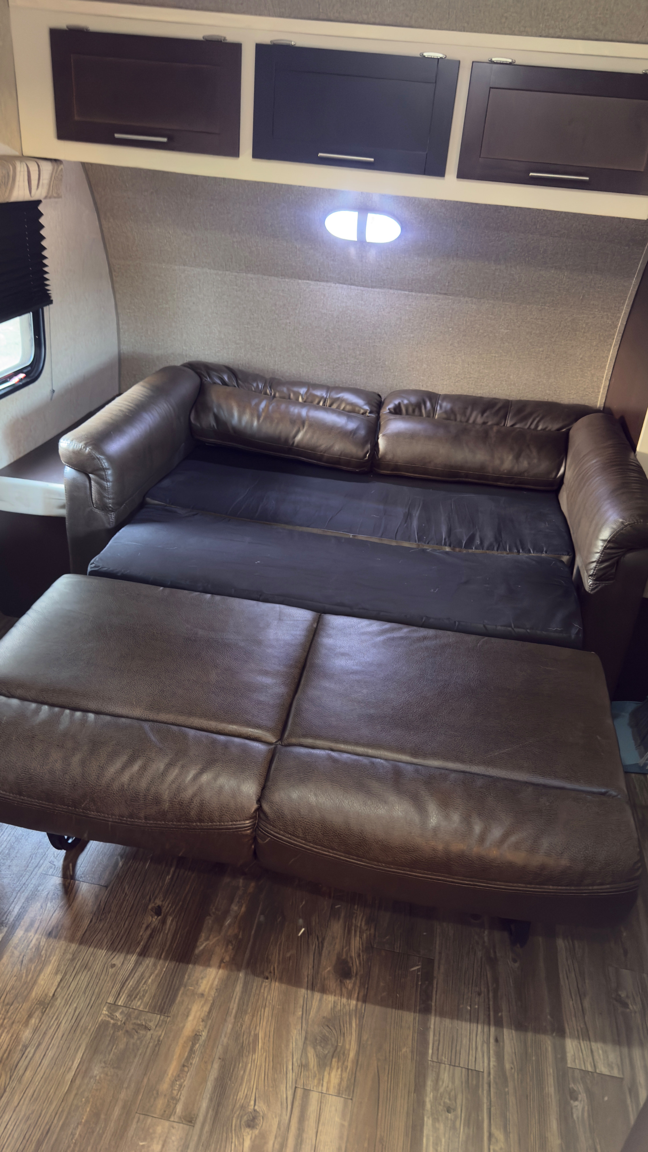 RV rental: brown leather pull-out sofa converts to a bed, with overhead cabinets and wood-look flooring.. Forest River Cherokee Grey Wolf Toy Hauler 2016
